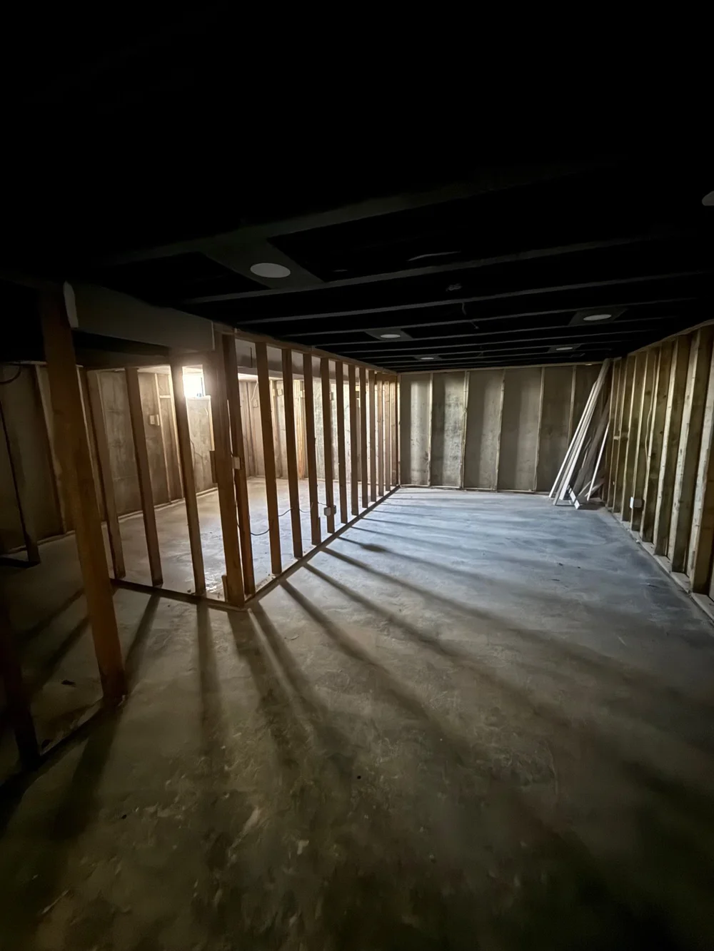 Drywall removal in Wichita, KS: basement walls stripped down to the studs