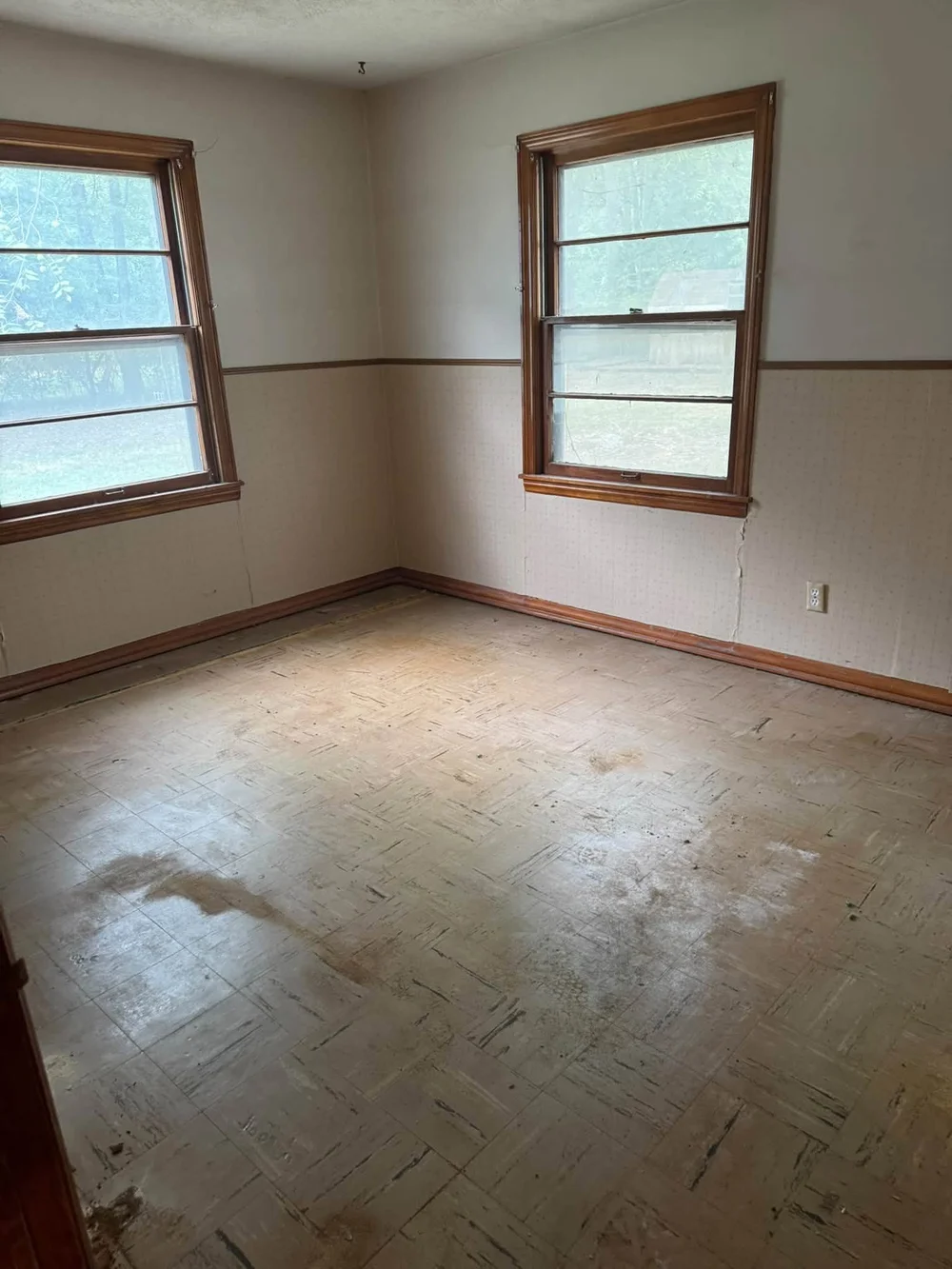 Interior demolition in Wichita, KS: bedroom flooring removed and room cleared for remodel