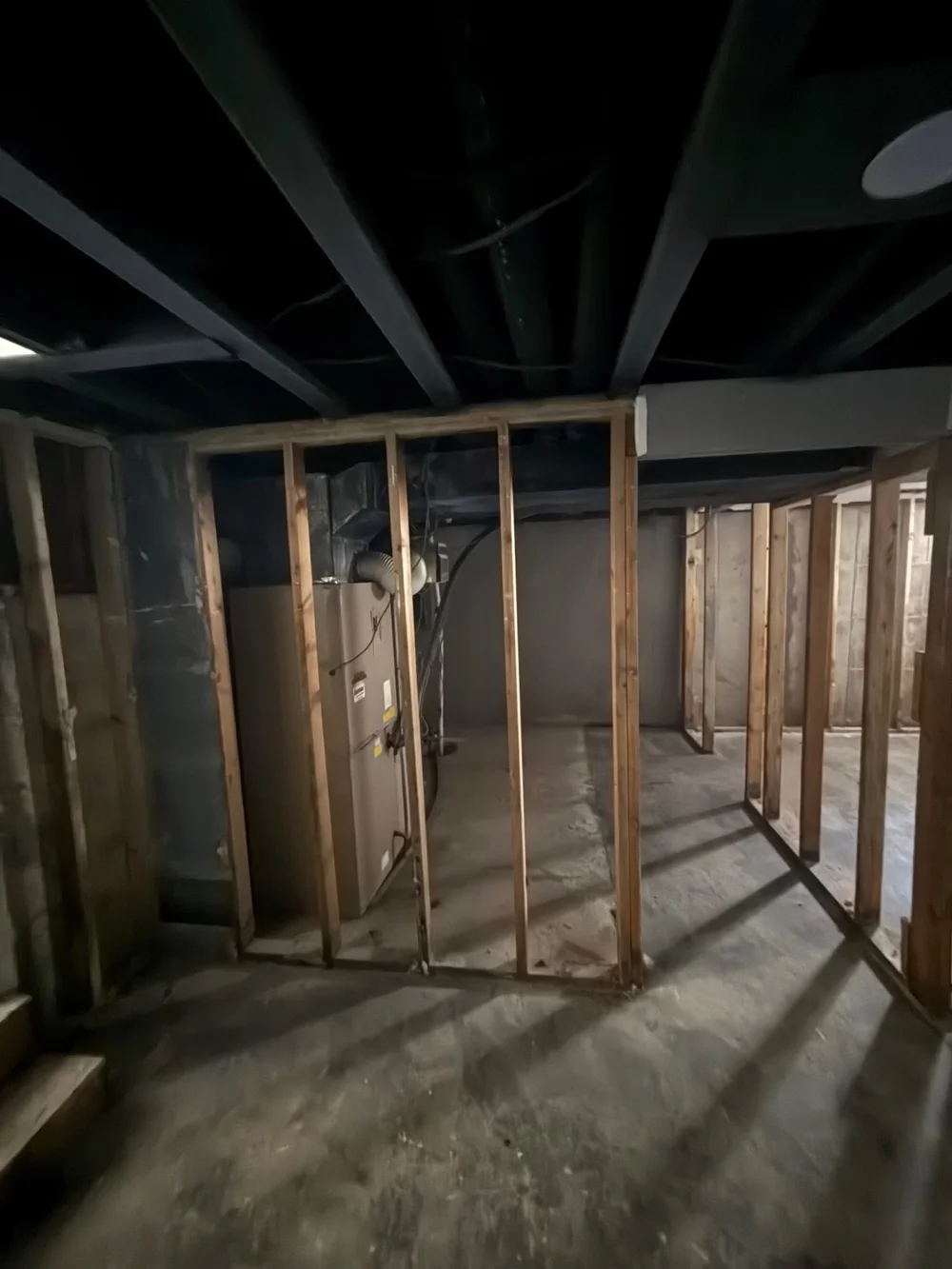 Interior wall and drywall removal in Wichita, KS: framing exposed and debris hauled away