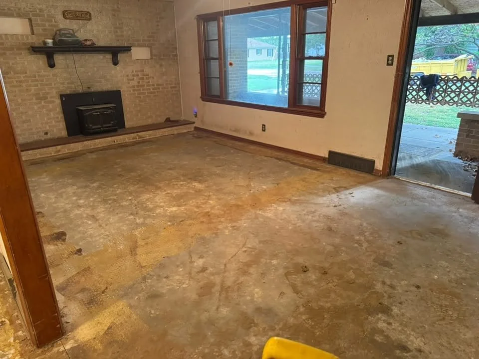 Interior demolition in Wichita, KS: living room flooring torn out down to the subfloor