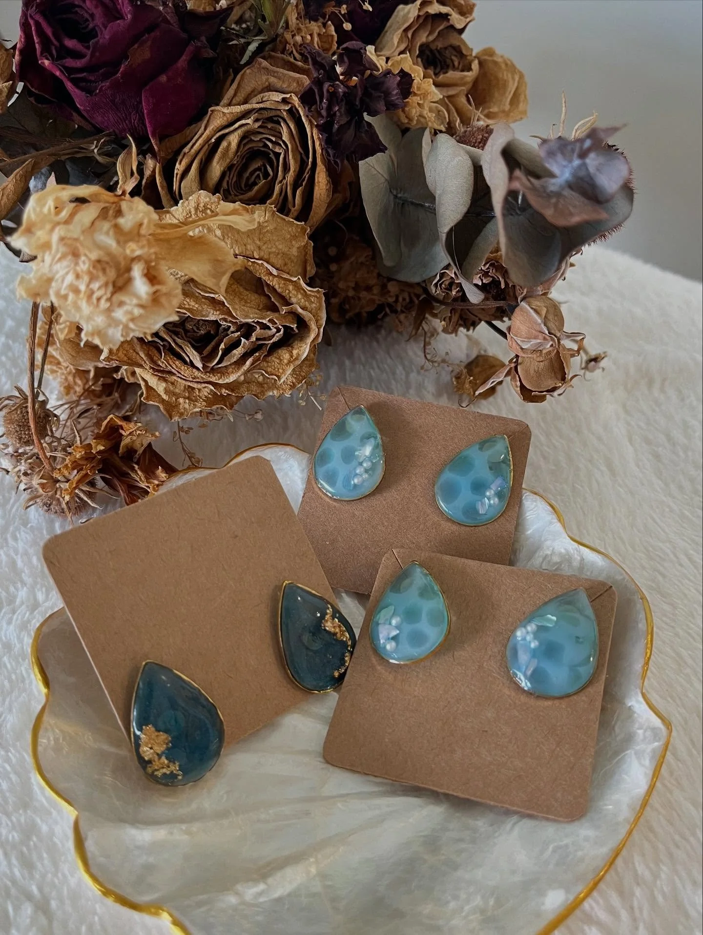 Ariel 

Shades of blue drift and glow in clear resin, like sun rays filtering through the ocean depths. Calming, luminous, and endlessly wearable.