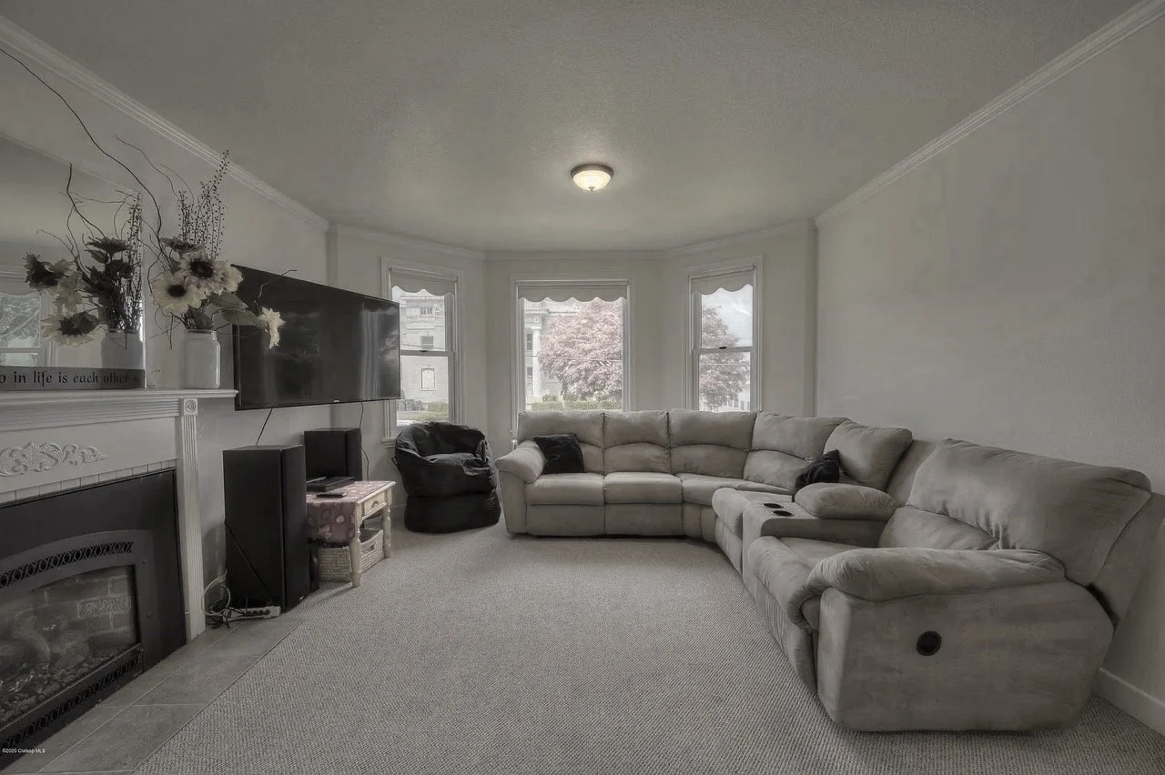 The problem: The narrow room with both the bay window and the fireplace being focal points, the tv placement was the biggest challenge. The fireplace was leaking, and the hearth tile was cracked and poorly installed.