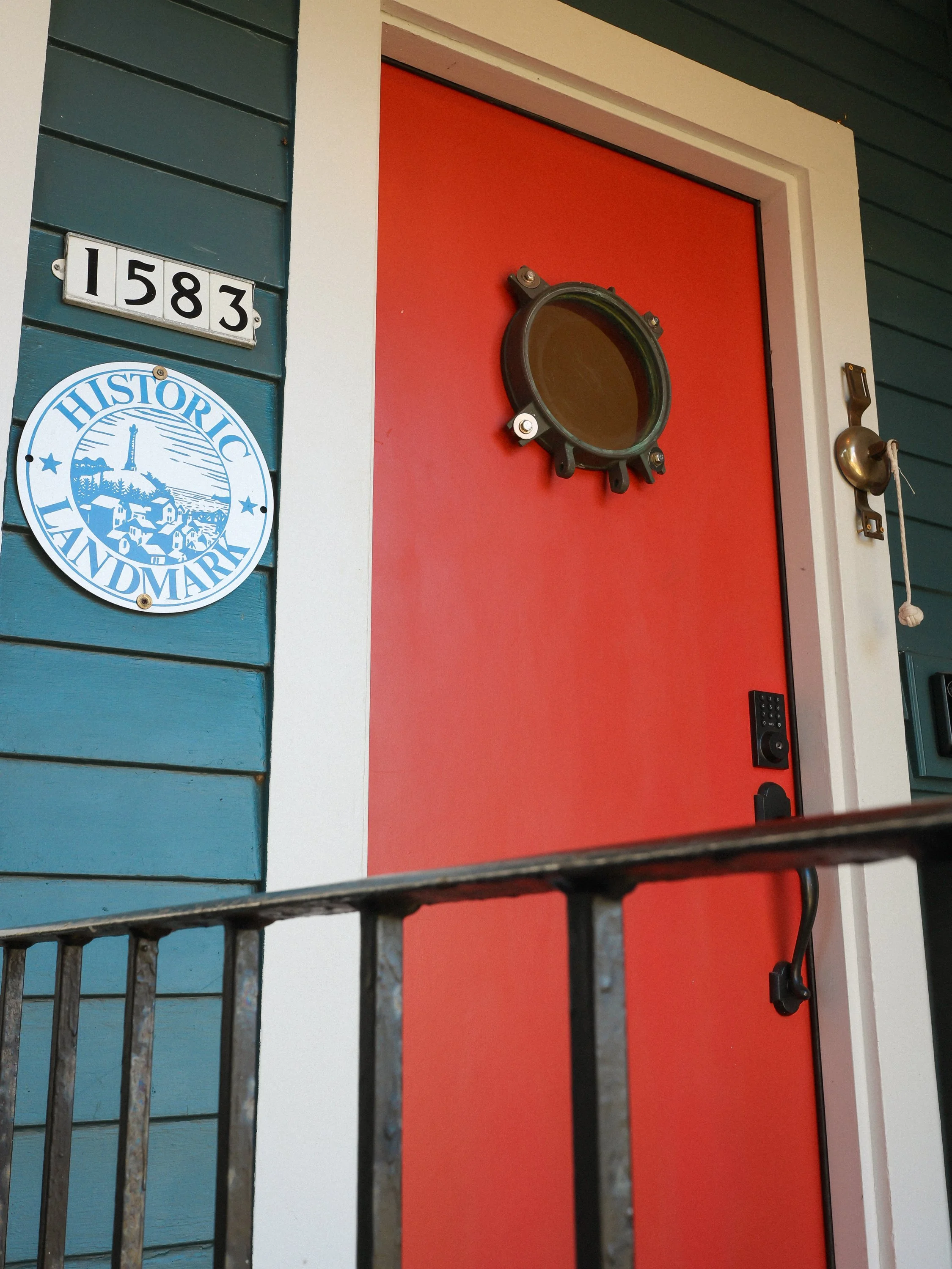 The problem: builder grade door. The fix: Paint it red and install an antique porthole.