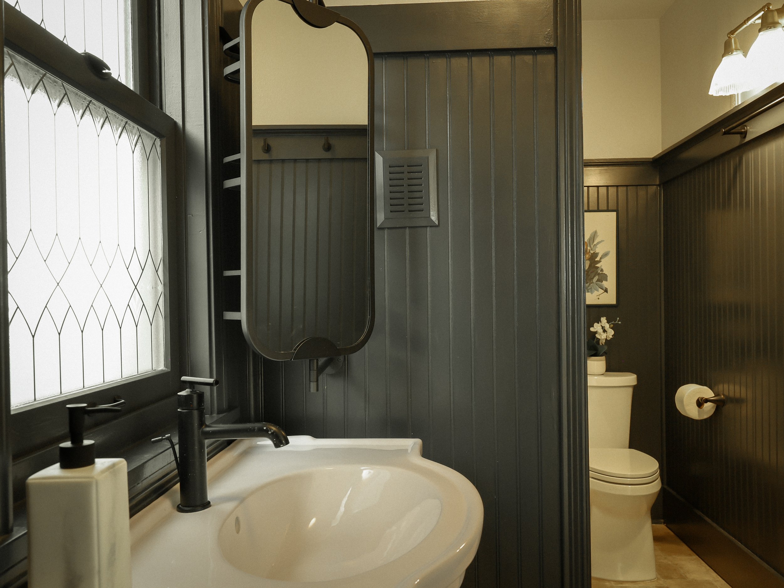 The Fix: By moving the sink in front of the window, it allows easy access to the toilet room. The shiplap clad in "railings" by farrow and ball makes a dramatic statement.