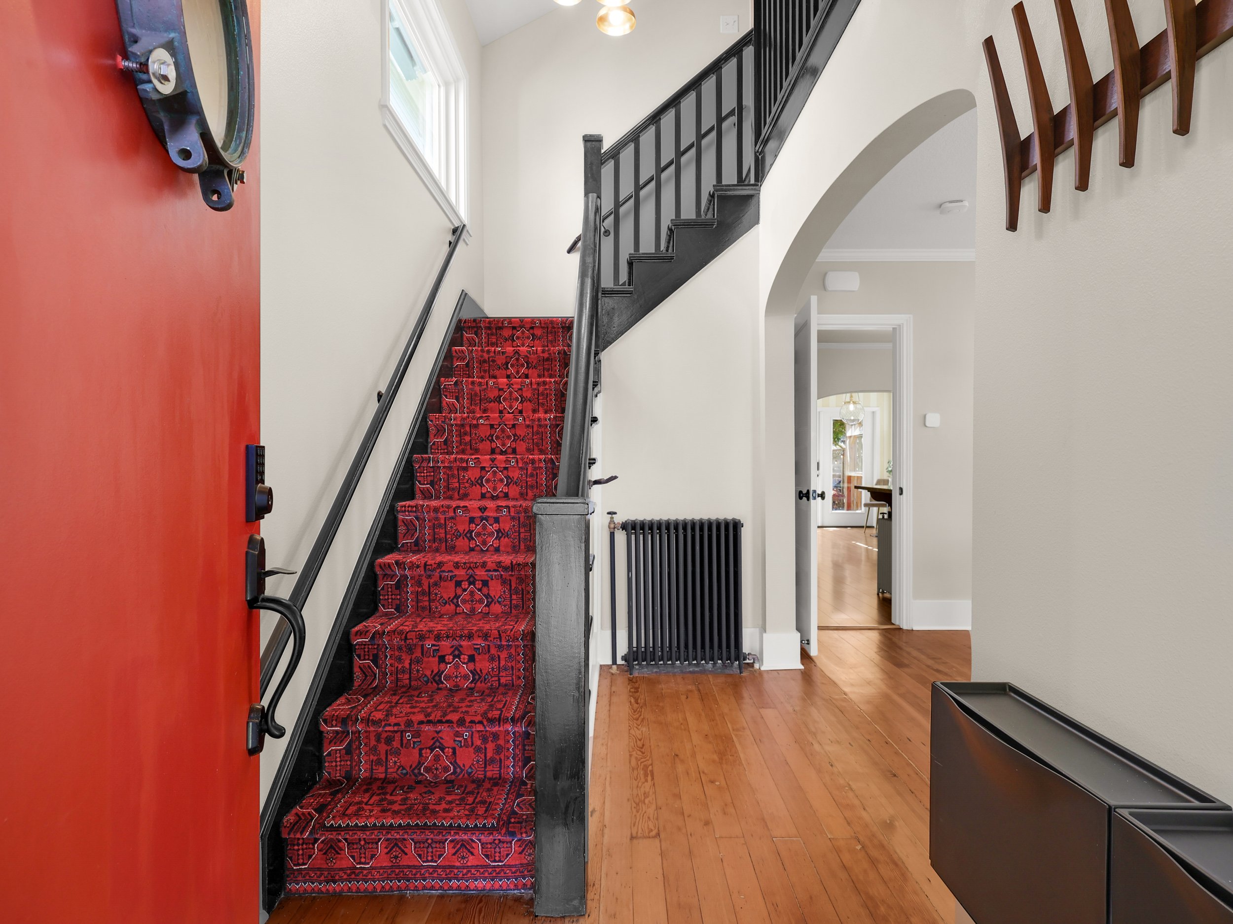 The fix: The stair runner is a custom woven pure wool rug. The rug adds a pop of color as it is the first thing you see when opening the door.