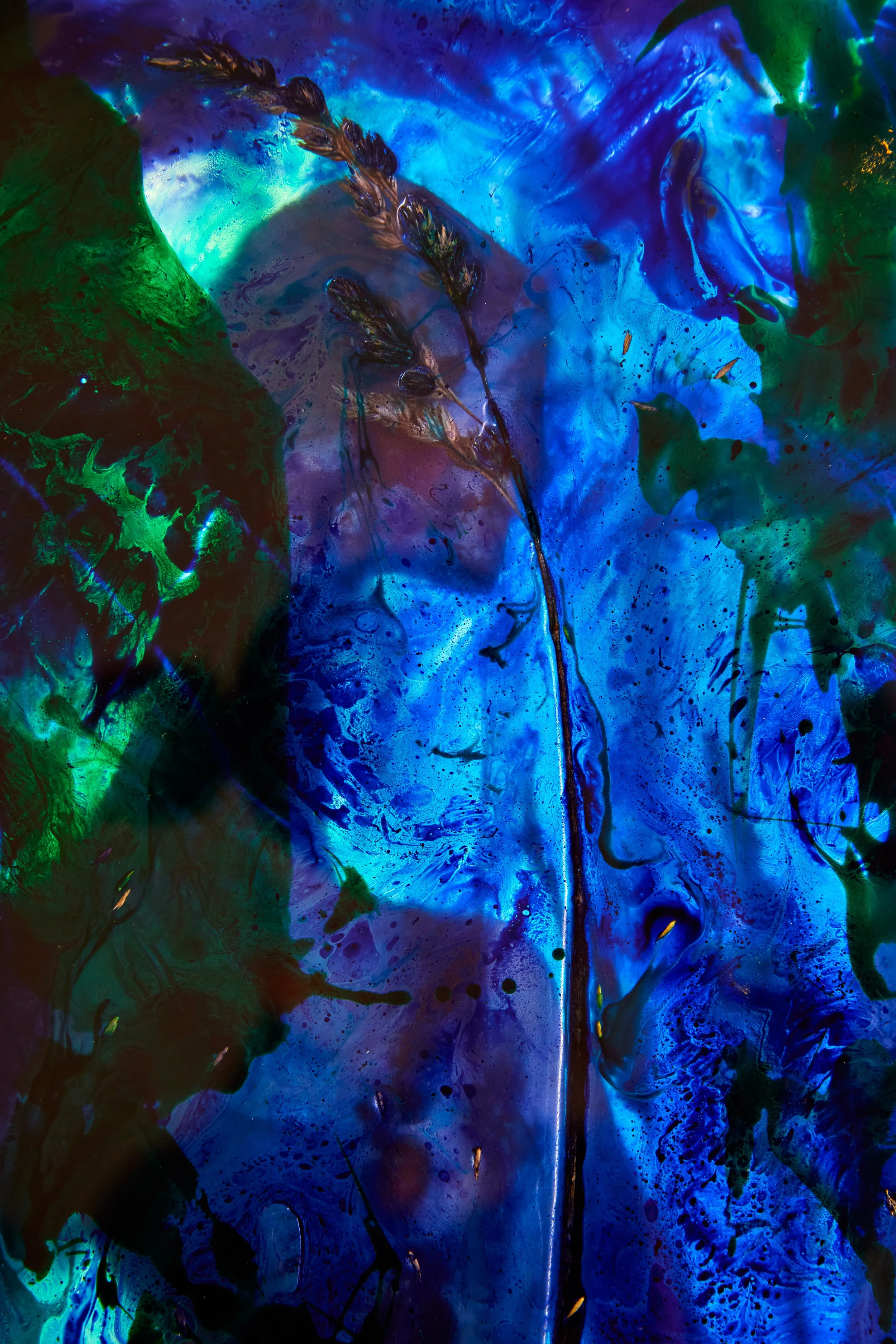 A vibrant abstract artwork featuring a deep blue background with green and black accents, resembling a feather or plant with textured details.