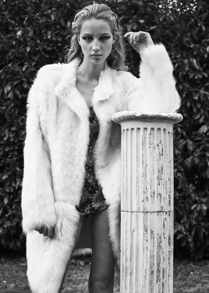 Edge-to-edge coat, deep in thought...