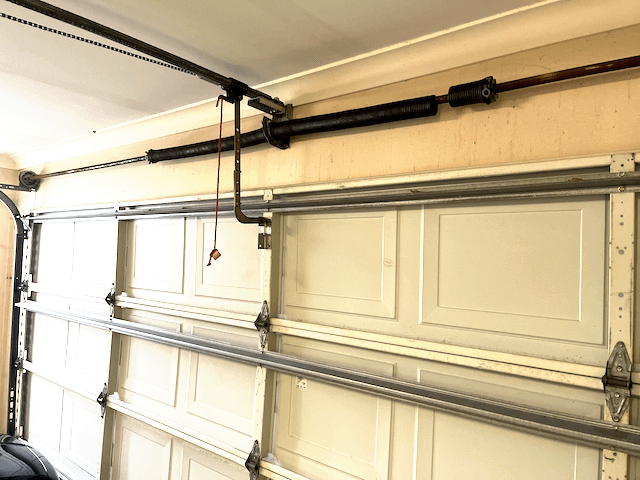 The inside of a garage door showing the springs at the top.