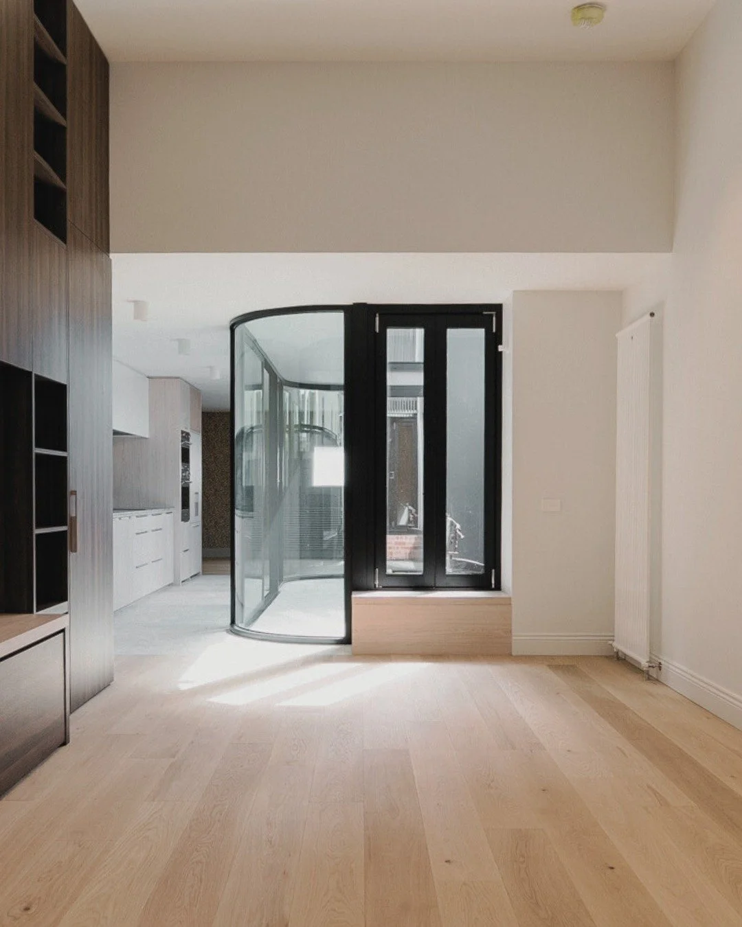 Warm timber tones meet clean, contemporary lines. 

The seamless flow from living space to outdoor sanctuary is defined by sleek black-framed doors that frame natural light beautifully.

Custom joinery in rich wood grain creates both function and vis