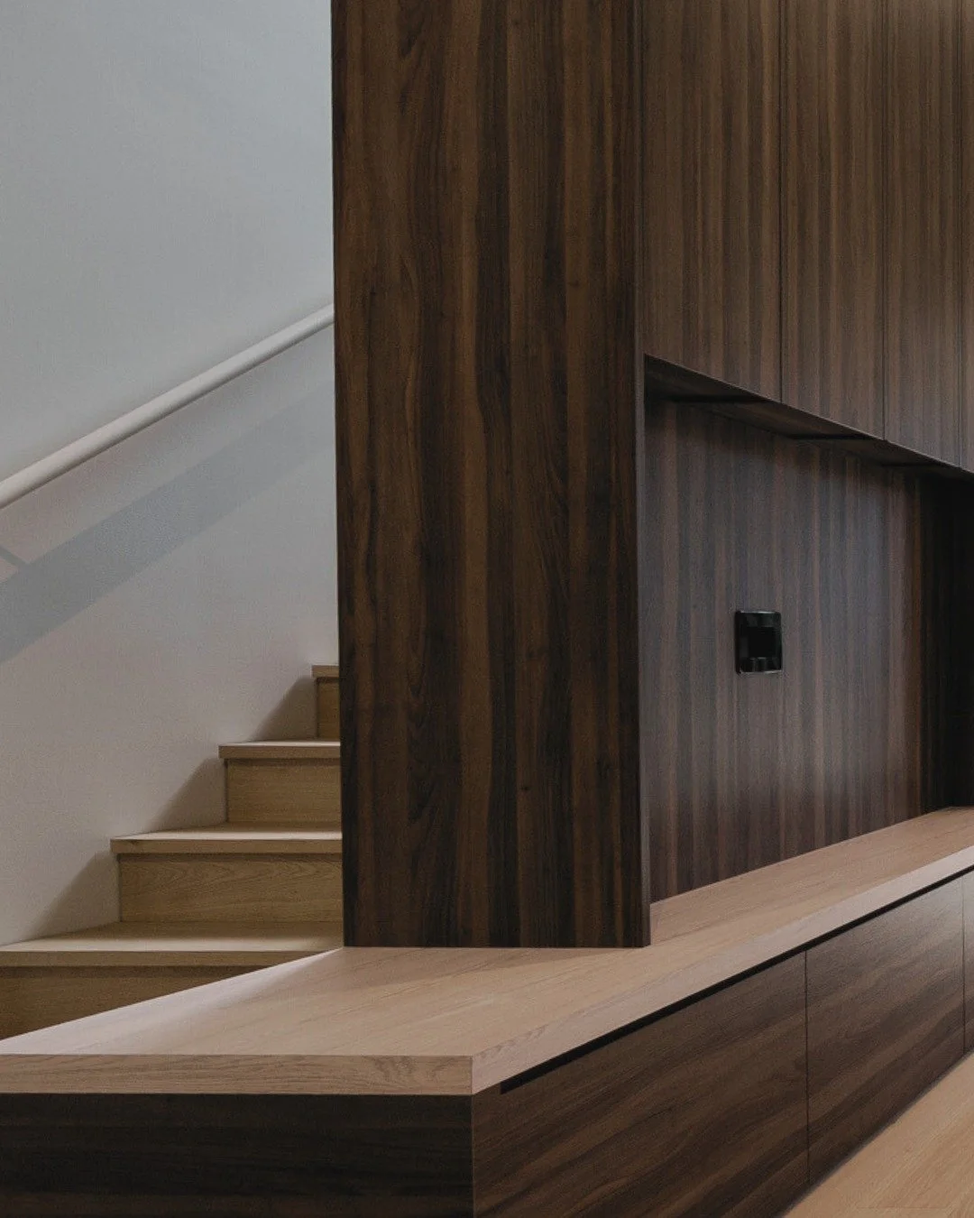 Warm timber tones meet clean, contemporary lines. 

The seamless flow from living space to outdoor sanctuary is defined by sleek black-framed doors that frame natural light beautifully.

Custom joinery in rich wood grain creates both function and vis