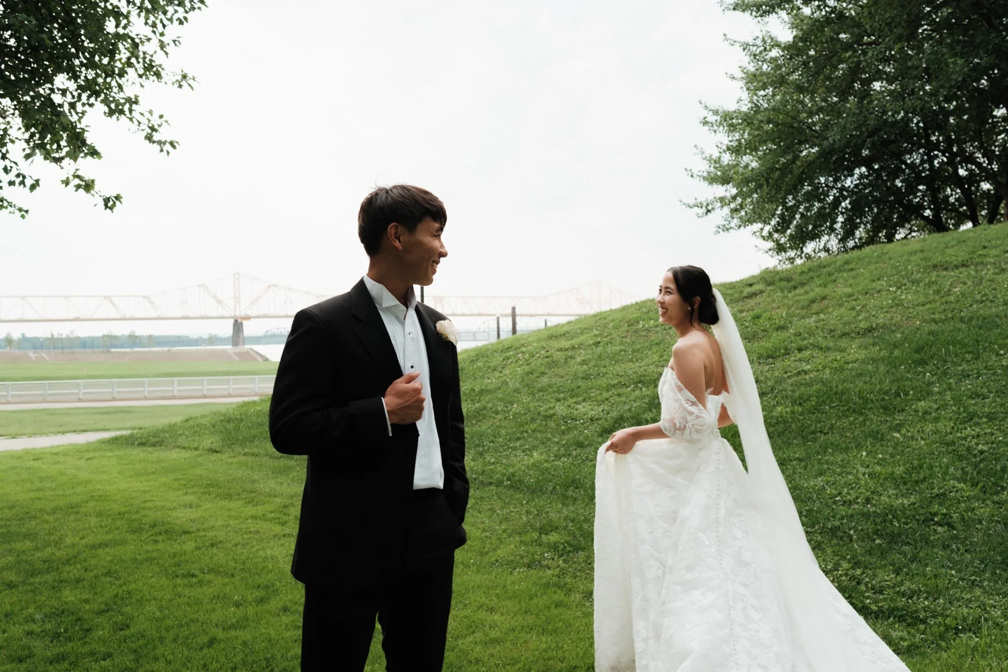 Groom admiring the bride as she circles around him during wedding portraits