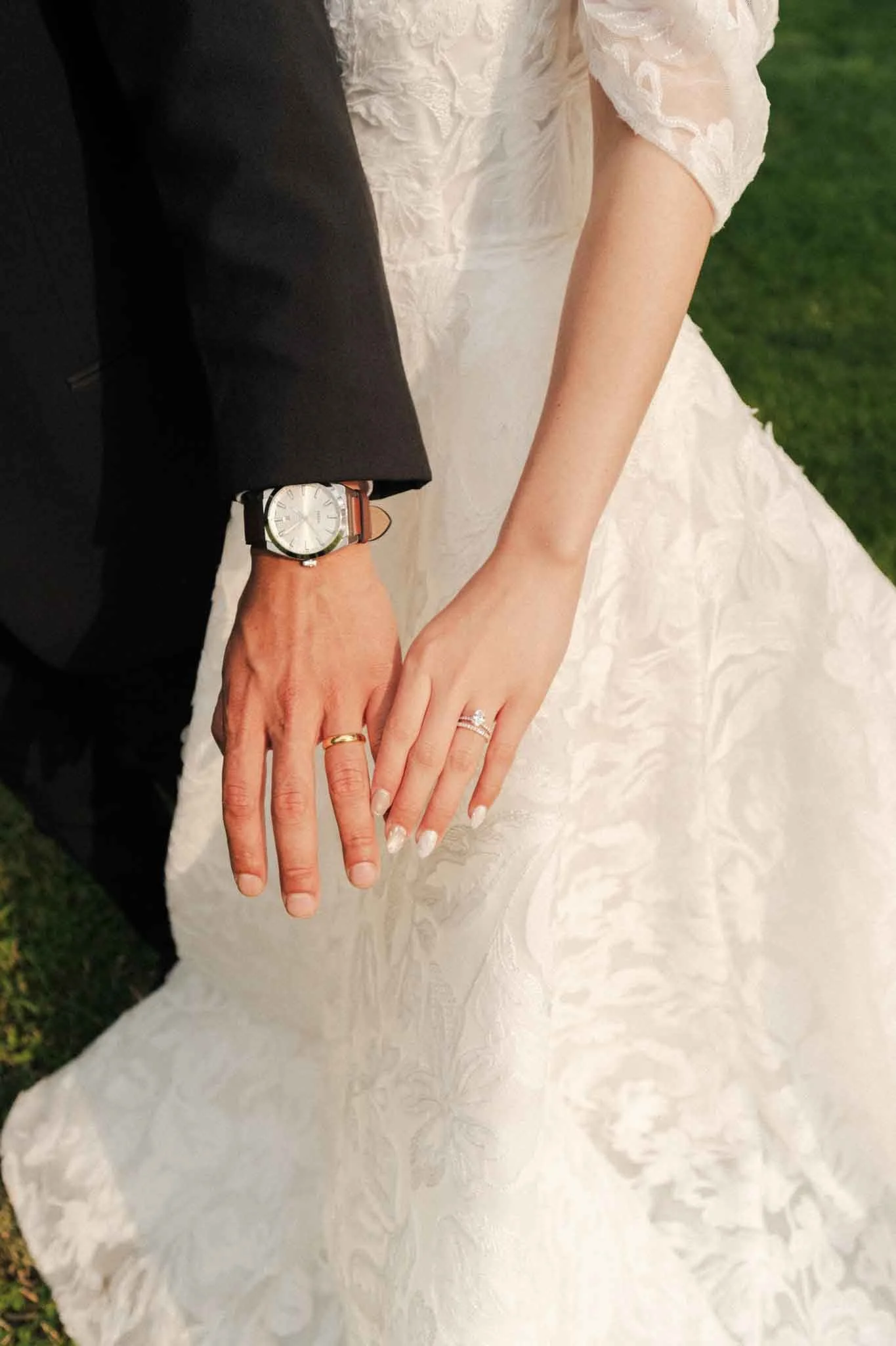 Close-up shot of the bride and groom showing off their wedding rings