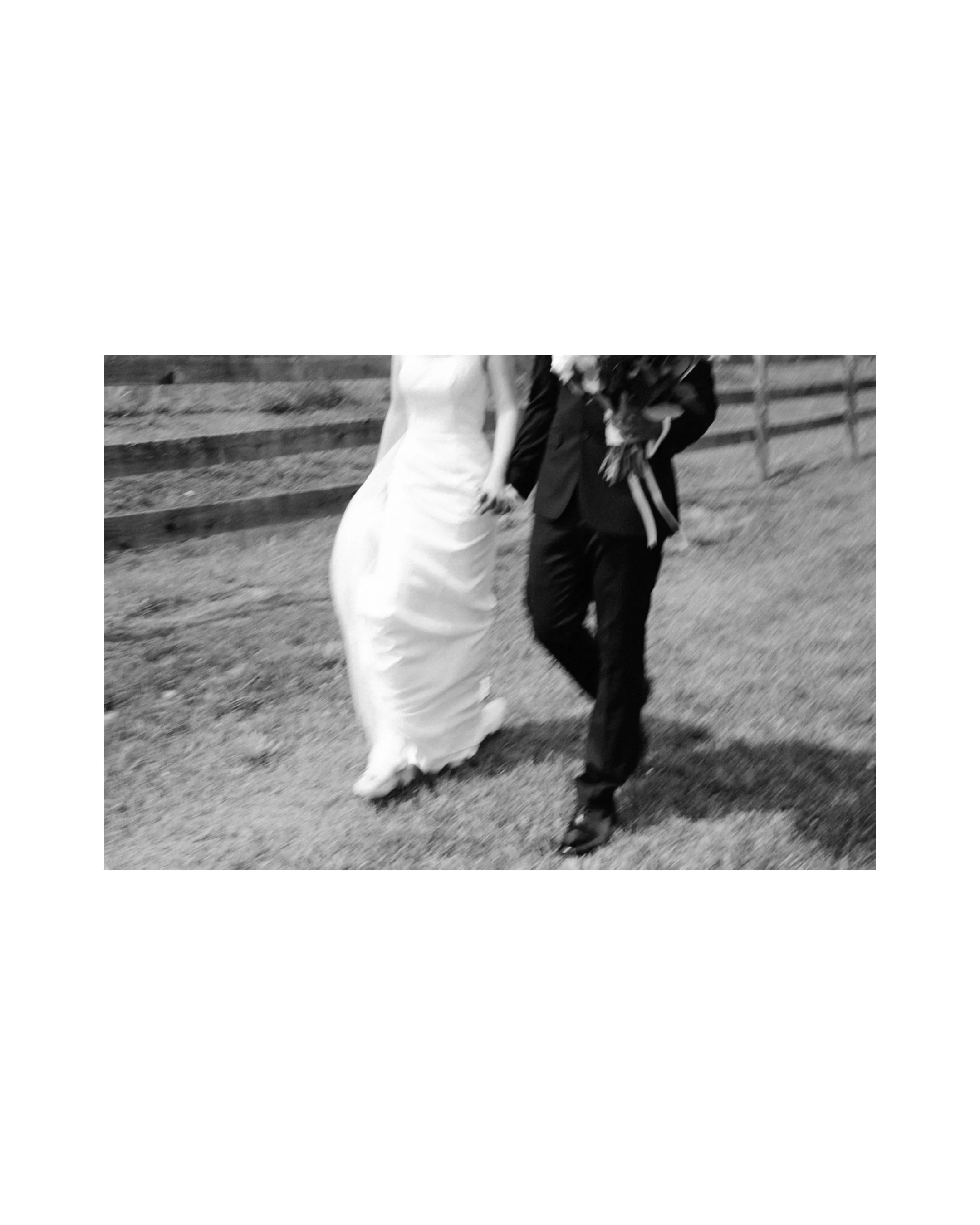 Artsy, blurry photo of the bride and groom walking