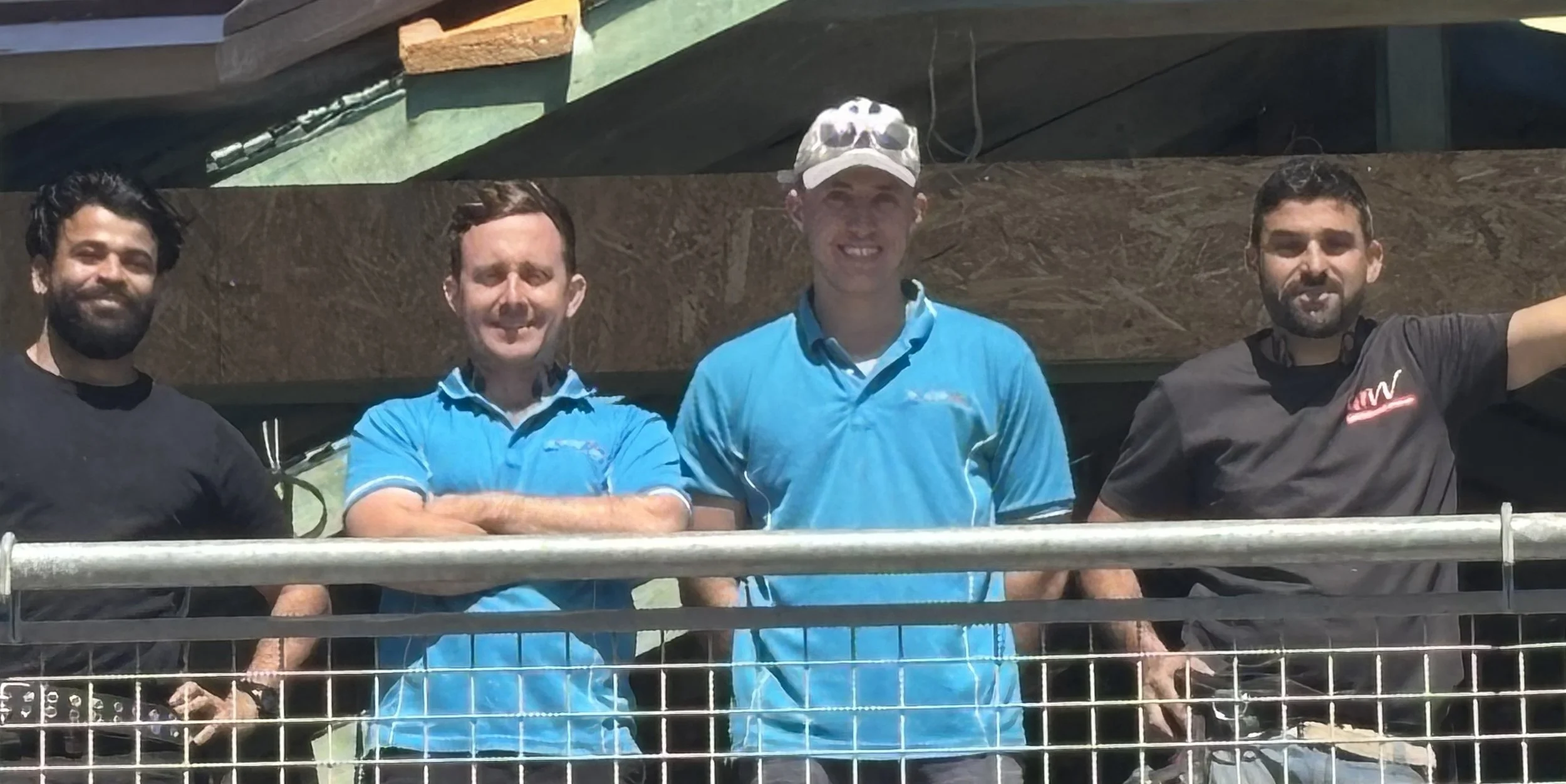 image of electricians from Price Family Electrical standing on the second story of a home being renovated