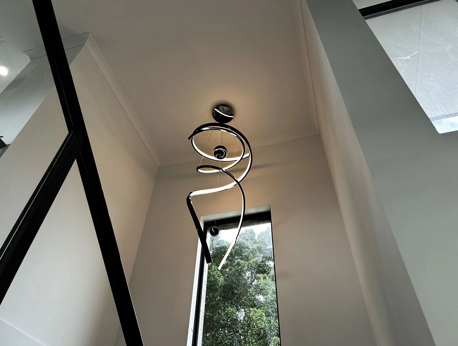 image of a modern pendant light hanging in hallway after being installed by Perth residential electricians