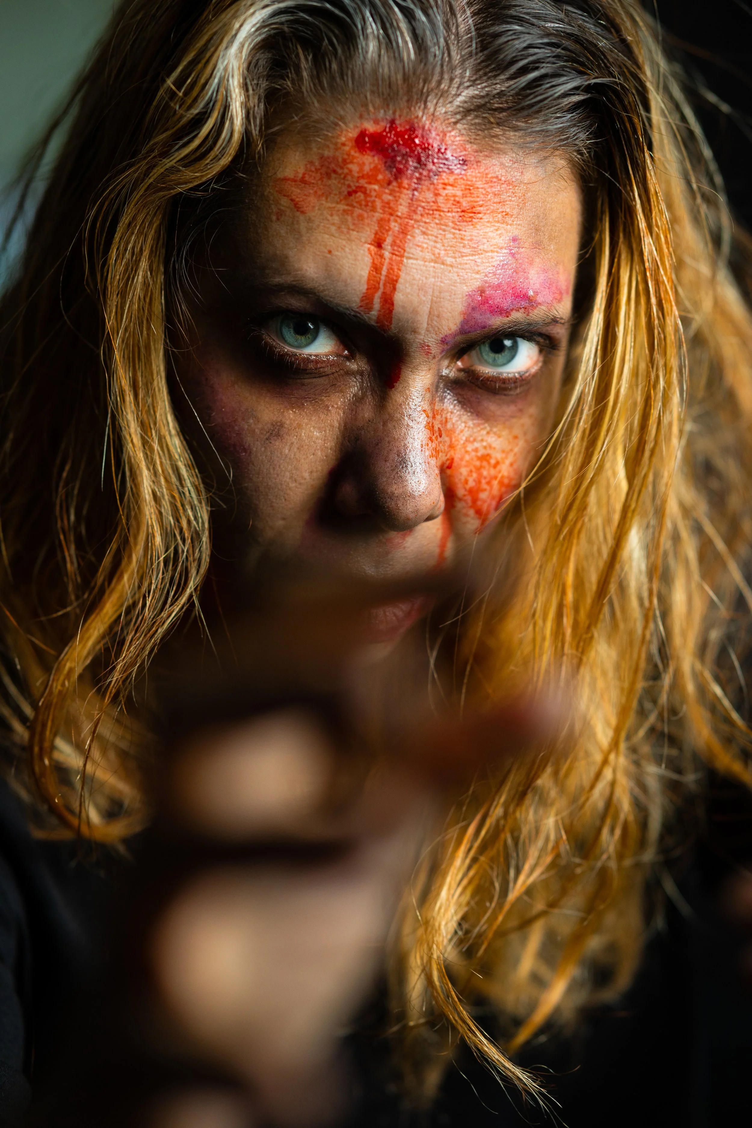 Cinematic portrait photography of female actor with special effects makeup and simulated wounds.