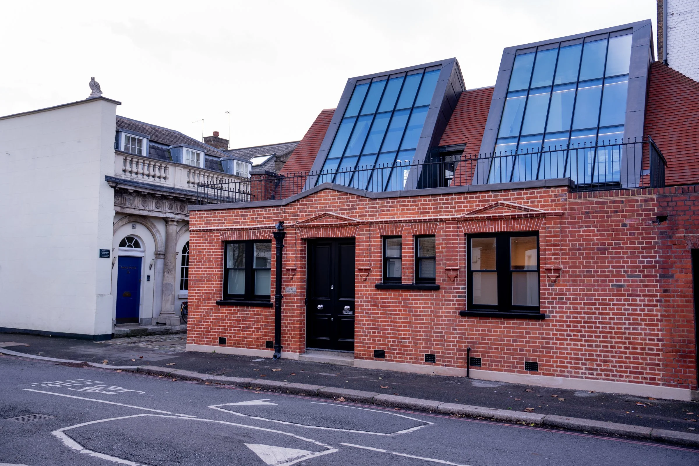 Street view of the Old Pottery Clapham showing original Victorian red brick facade with contemporary rooftop glazed extension