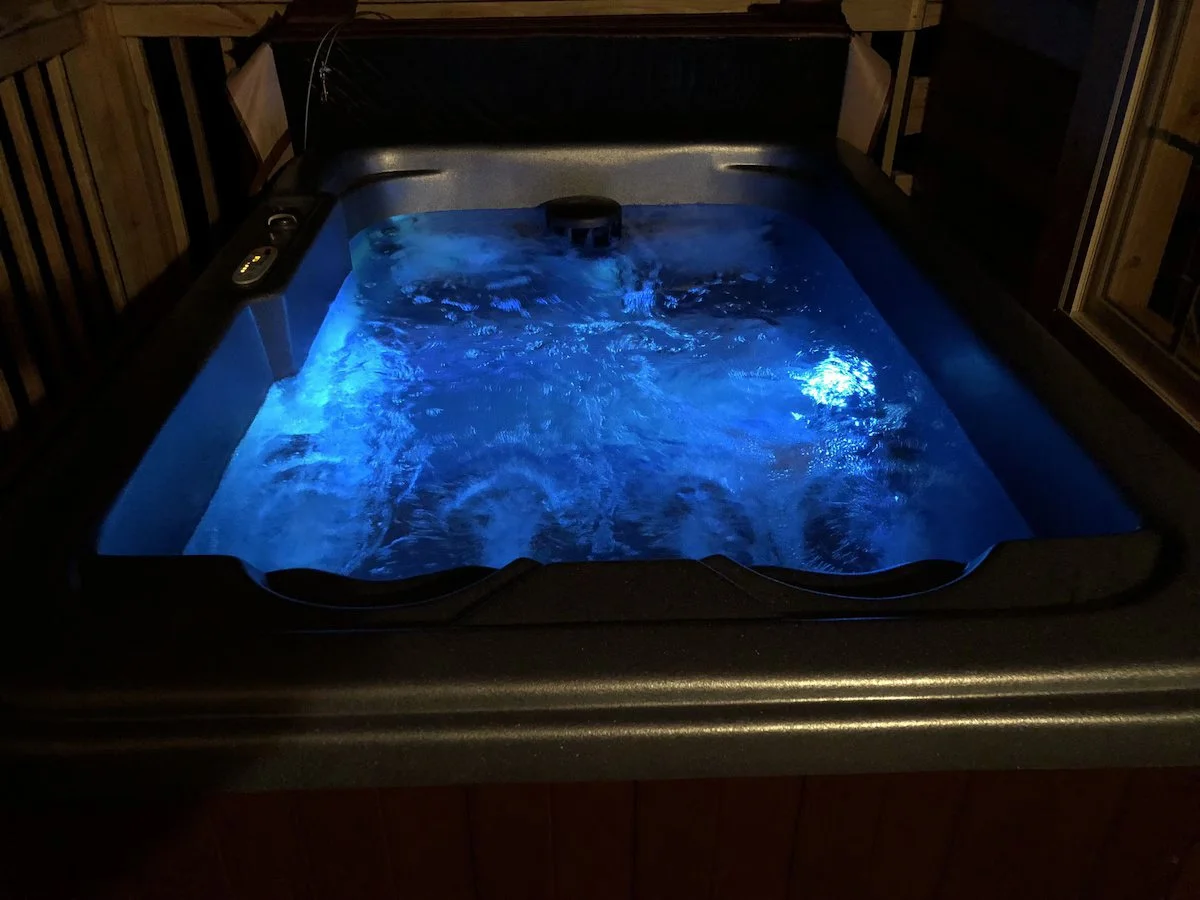 Private hot tub at Honeymoon Hideaway romantic cabin in Gatlinburg with scenic mountain views.