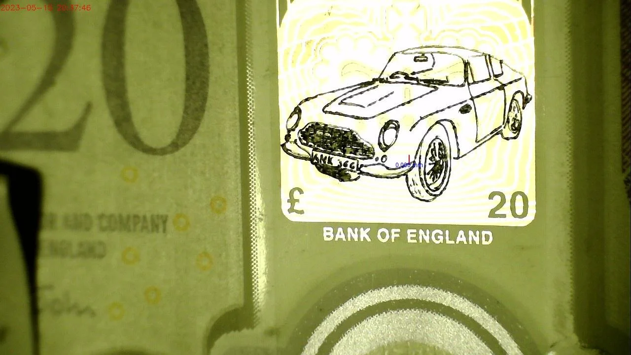 Graham Short's Micro Engraving of an Aston Martin (1) on a 20 Pound Note.jpg