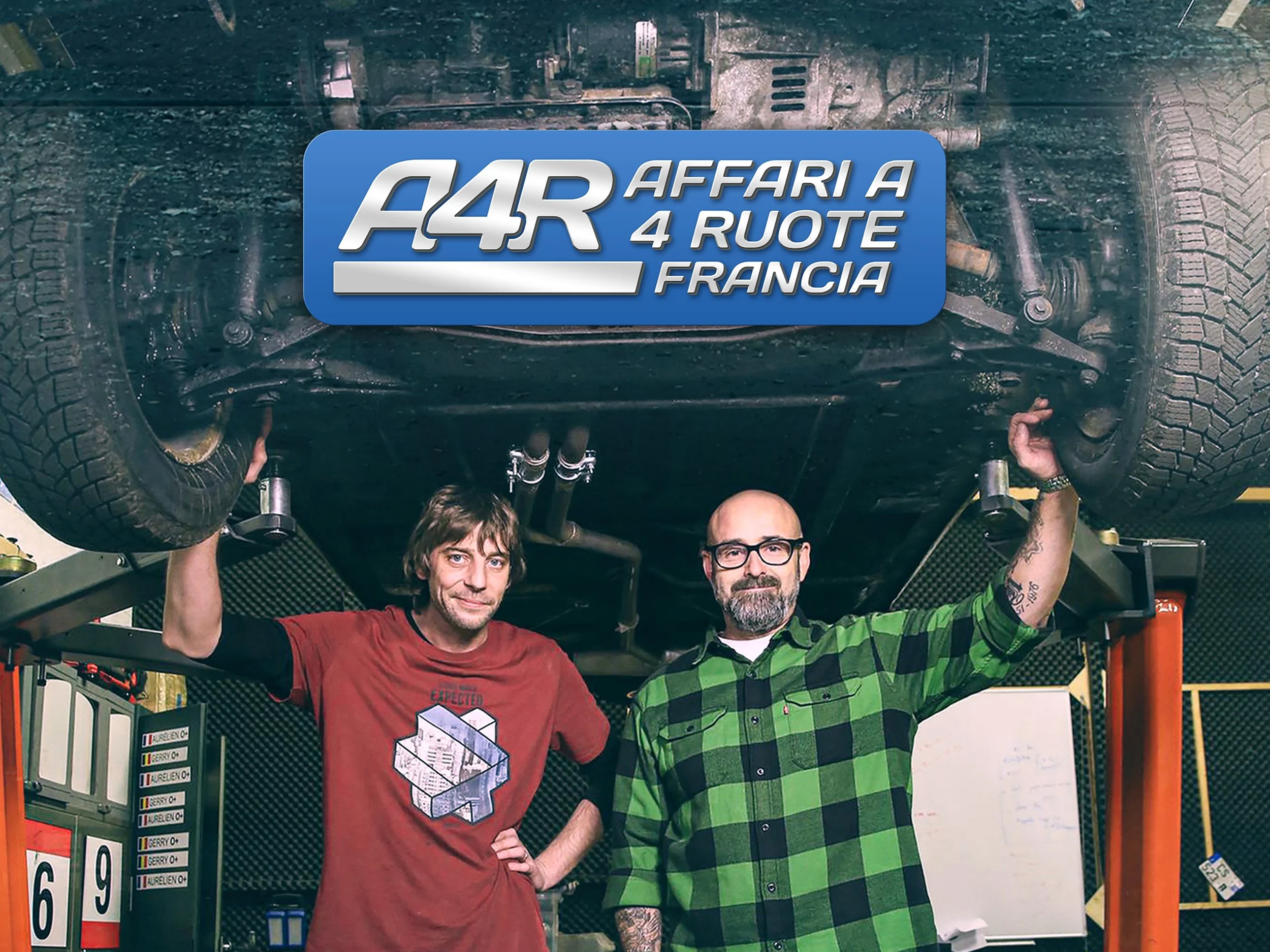 Due uomini in officina si sollevano sotto un'auto capovolta, che mostra il fondo motore. Sullo sfondo, attrezzi e strumenti di officina, e un grande logo azzurro con scritto 'A4R Affari a 4 Ruote Francia'.