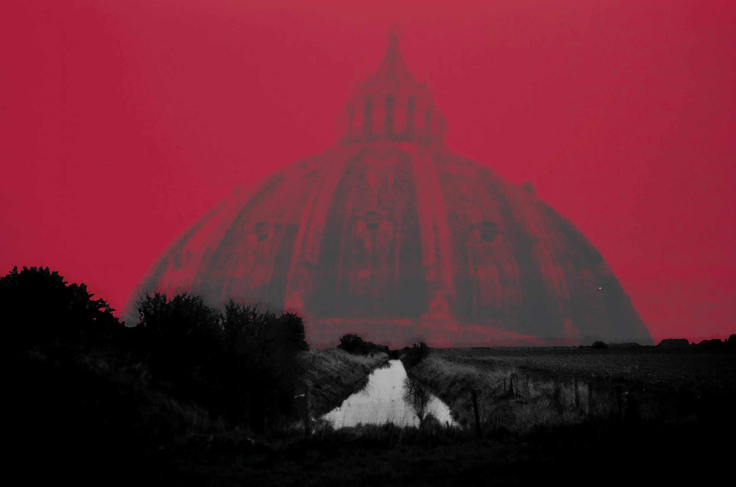 A large dome-shaped building with a spire on top, viewed from below during a red sky at dusk or dawn. Trees and bushes are silhouetted in the foreground.