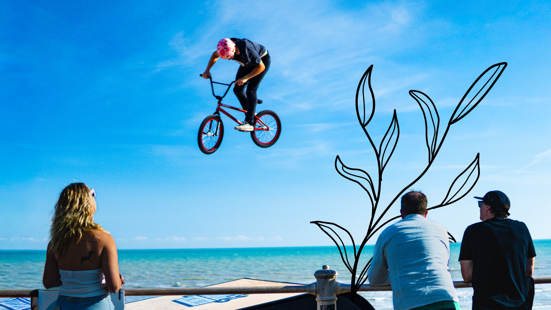 BMX rider in the air above a jump box.