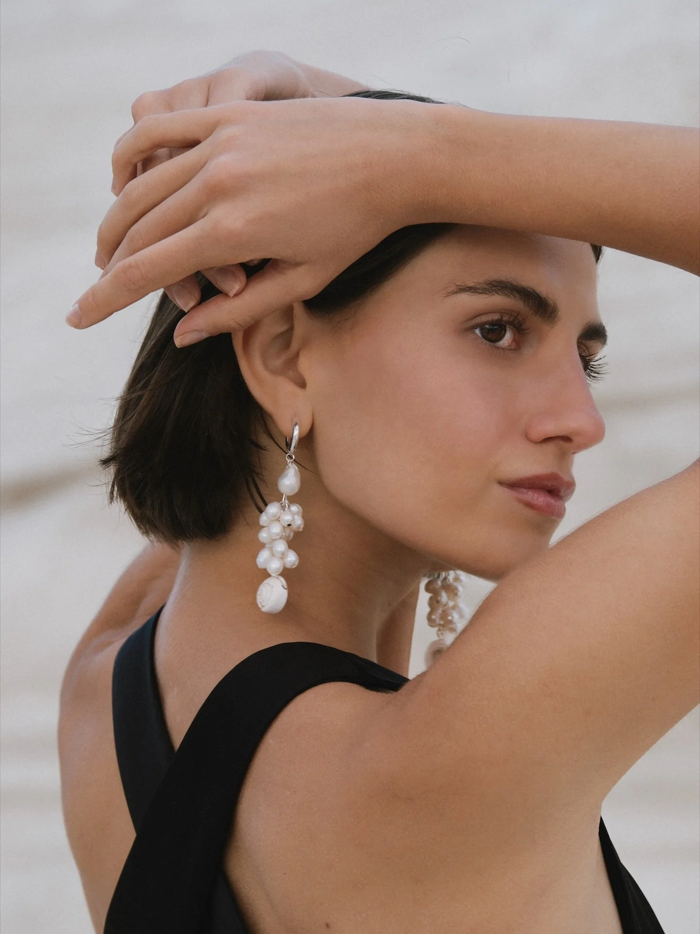 Our bestseller earrings: the &ldquo;Calypso&rdquo; hand crafted of freshwater pearls and a shiva shell. Our most popular pick for weddings overseas.