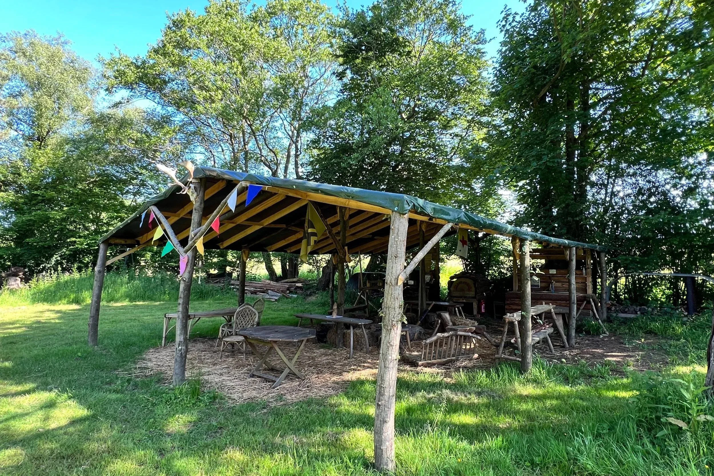  The Pole Barn  - A key feature for outdoor events and festivals, this covered social space has an open cooking fire, wood fired pizza oven, outdoor kitchen, running water and is surrounded by shelters and wild camping spaces, allowing you to immerse