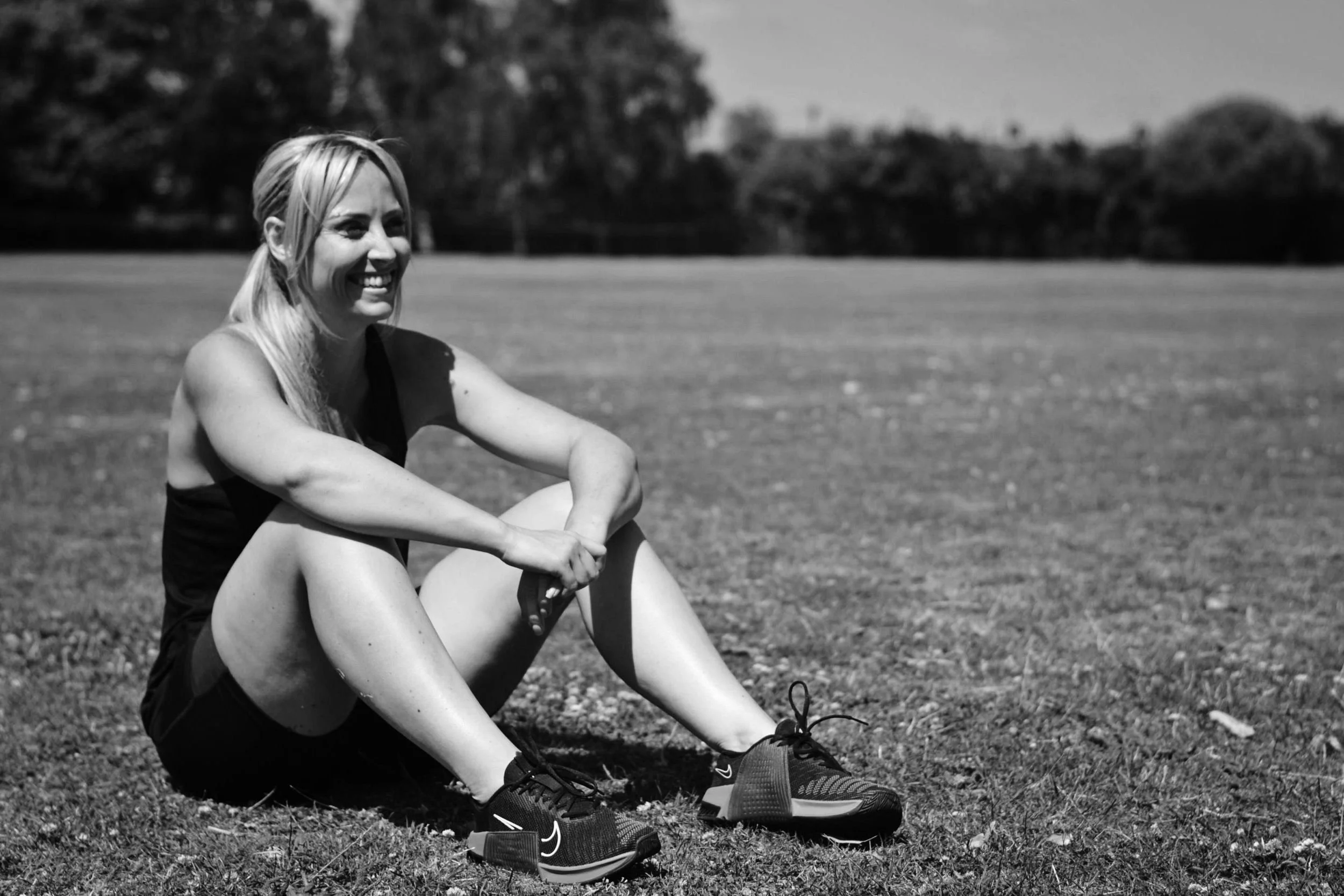 Vikki sitting on the grass smiling