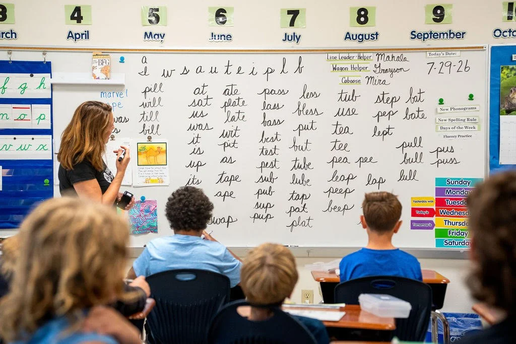 Teacher and students interacting in a Feller School classroom