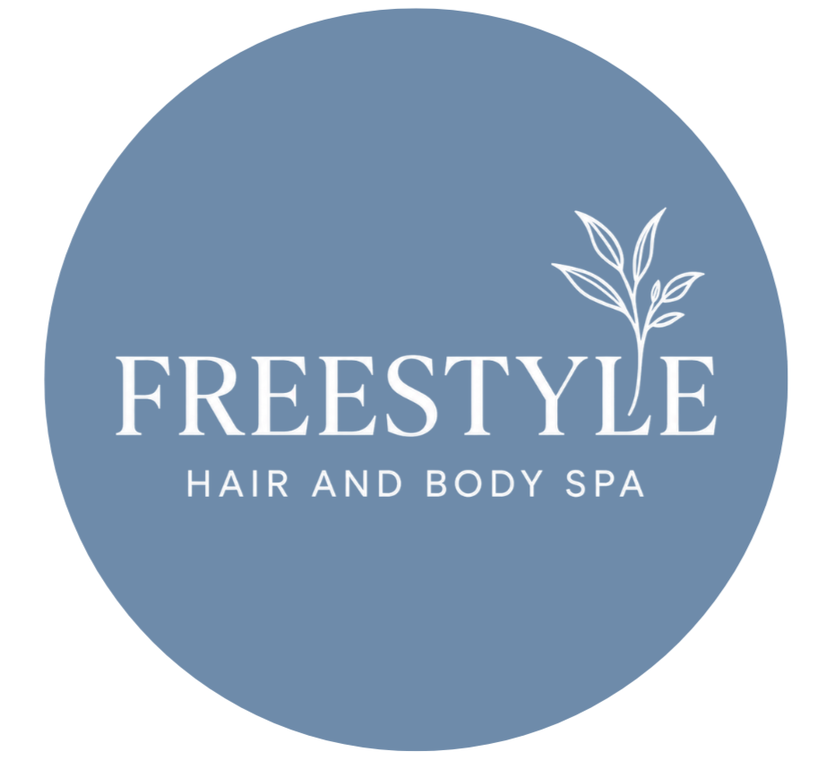 Logo of Freestyle Hair and Body Spa, featuring a light blue circular background, stylized plant graphic, and white text that reads 'FREESTYLE HAIR AND BODY SPA'.