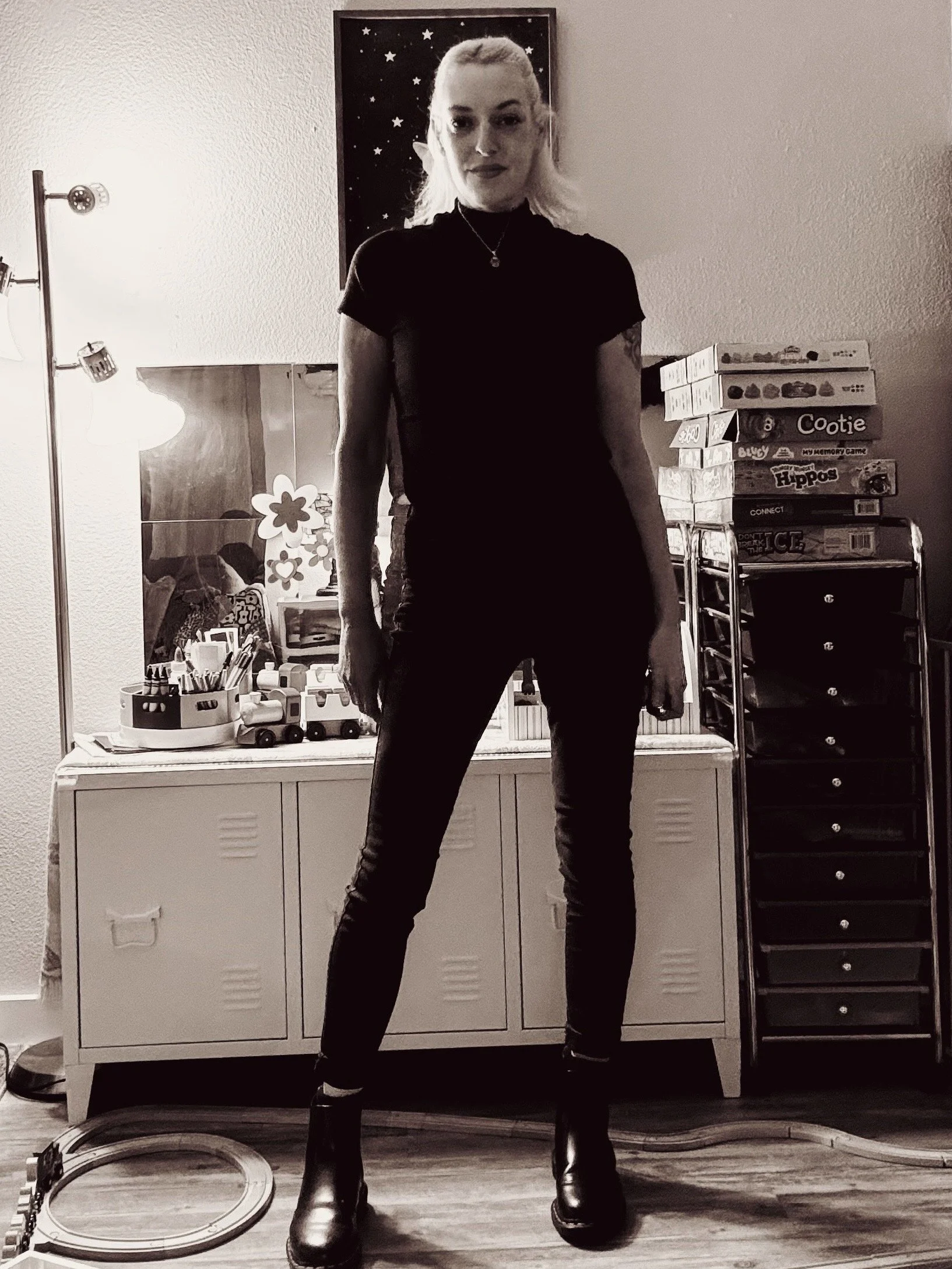 Rebekah standing inside the childcare space she built, surrounded by learning materials and a wooden train track.