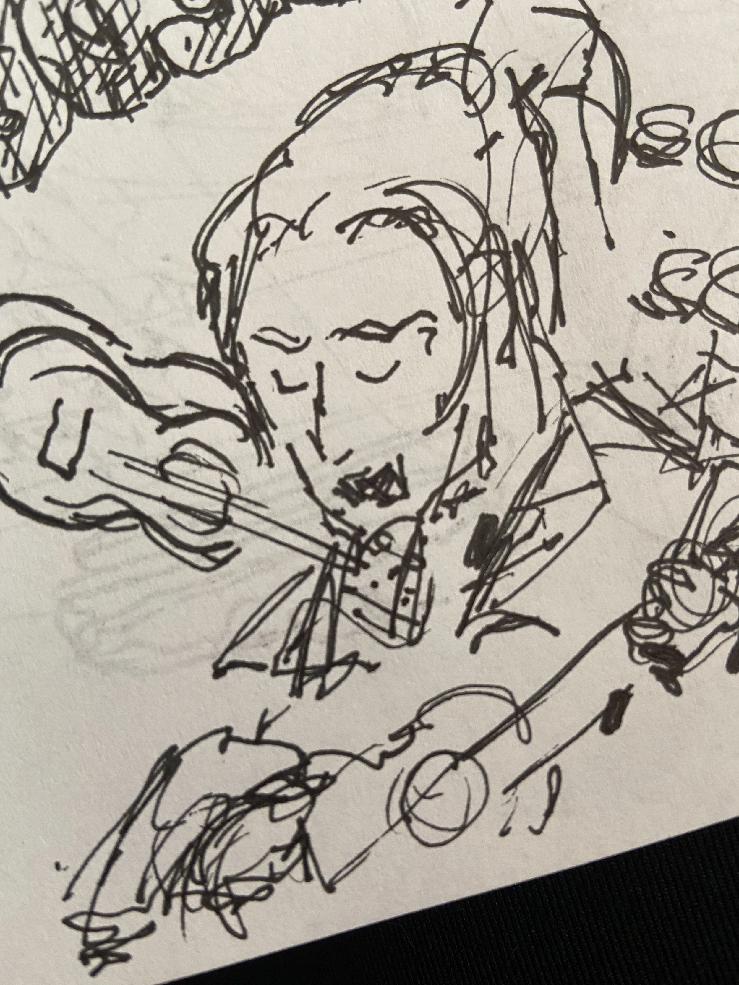 Loose ink drawing of the writer wearing her knit hat and holding a stringed instrument, recovered from a private sketchbook and dated December 27, 2020.