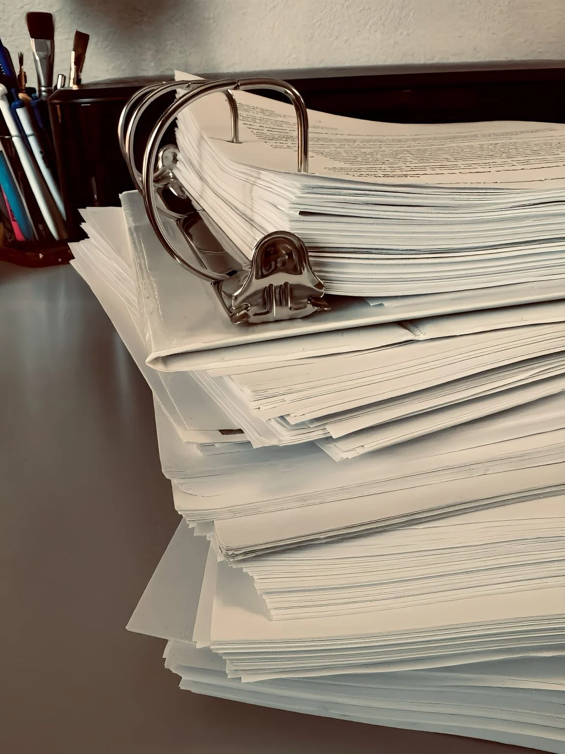 A large binder and stacks of preserved records from the I Am His Karma survivor archive.