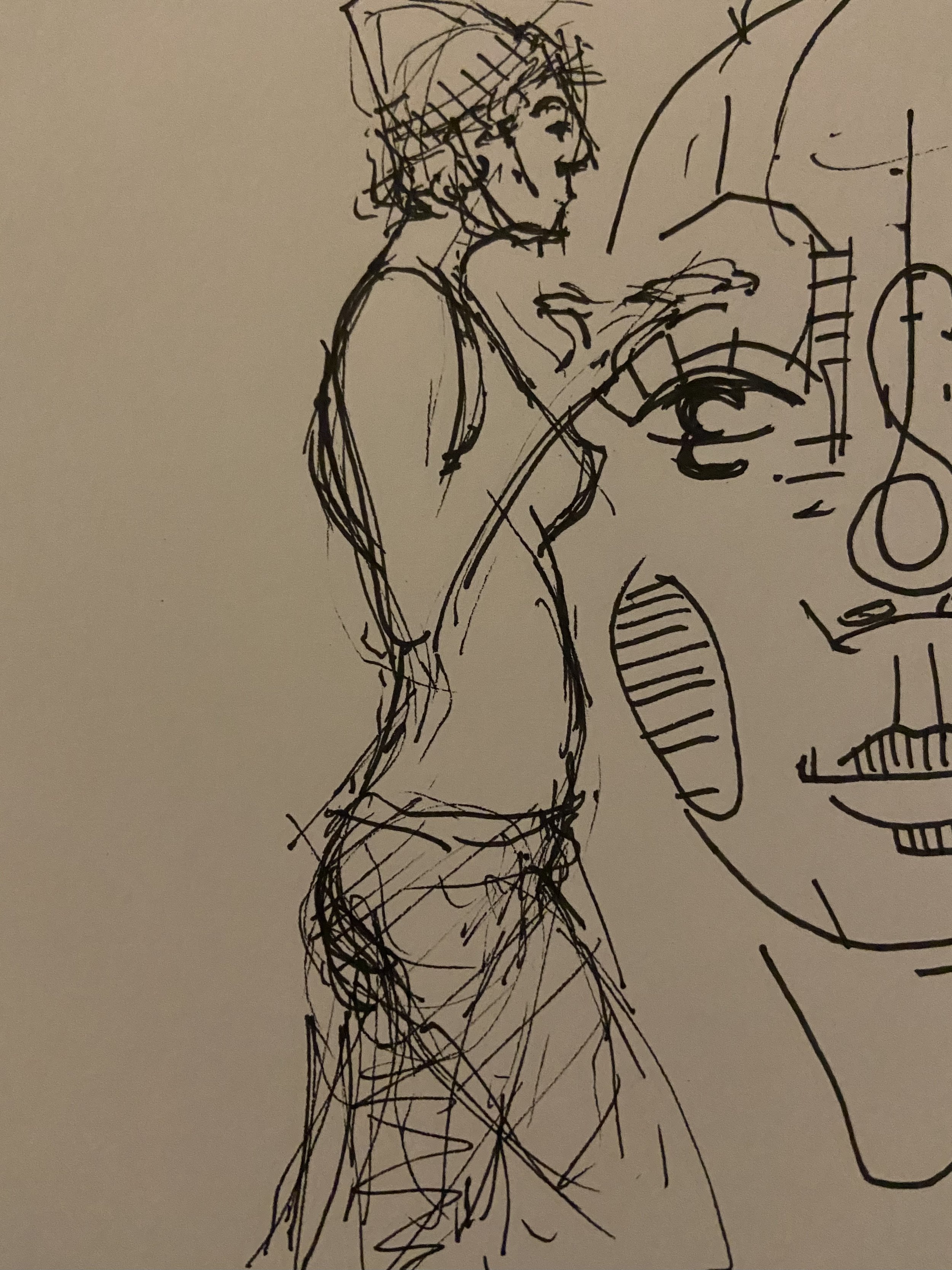 Ink drawing of the writer standing in profile beside a large abstract face, wearing her recognizable knit hat and clothing, dated February 24, 2021.