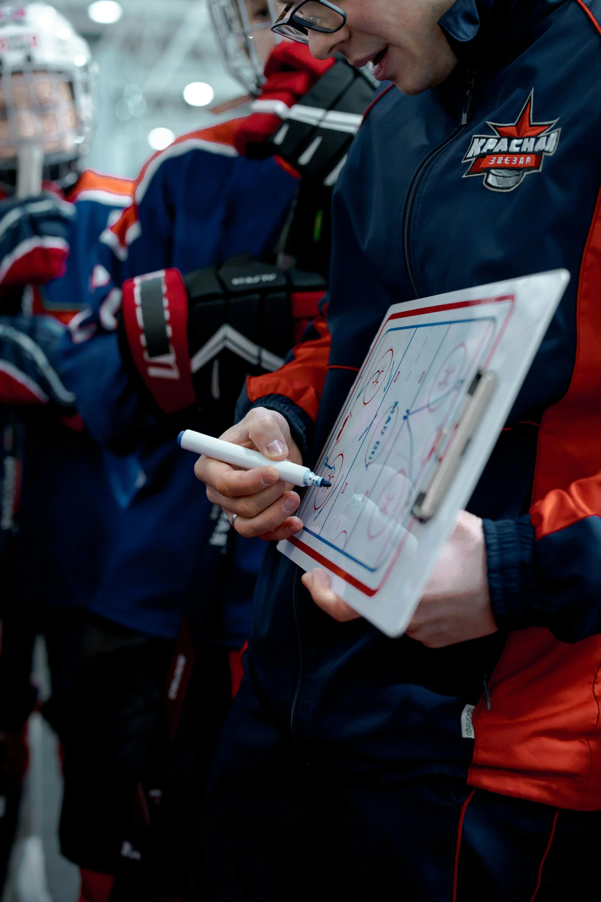Coach communicating with athletes during team development session