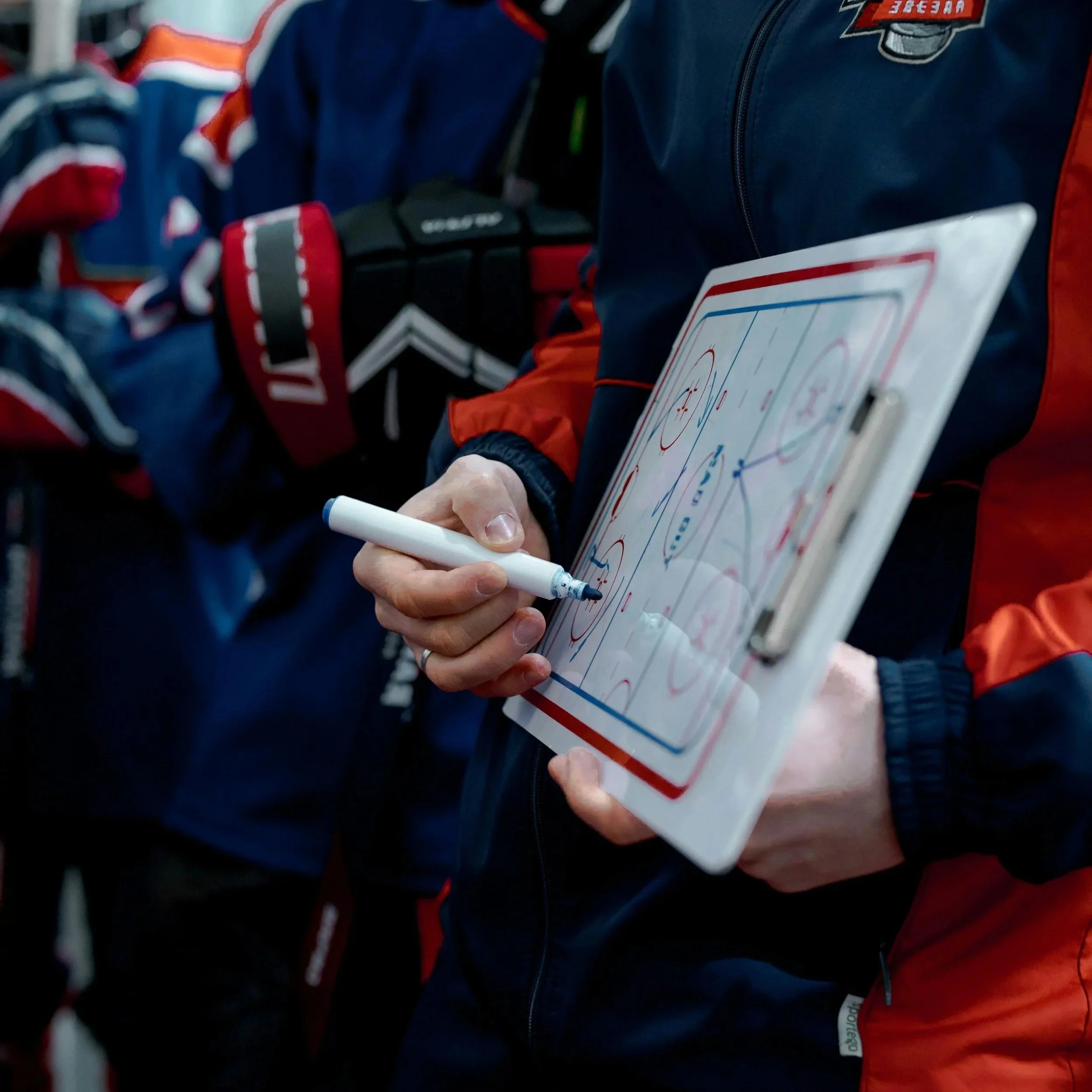 Coach communicating with athletes during team development session