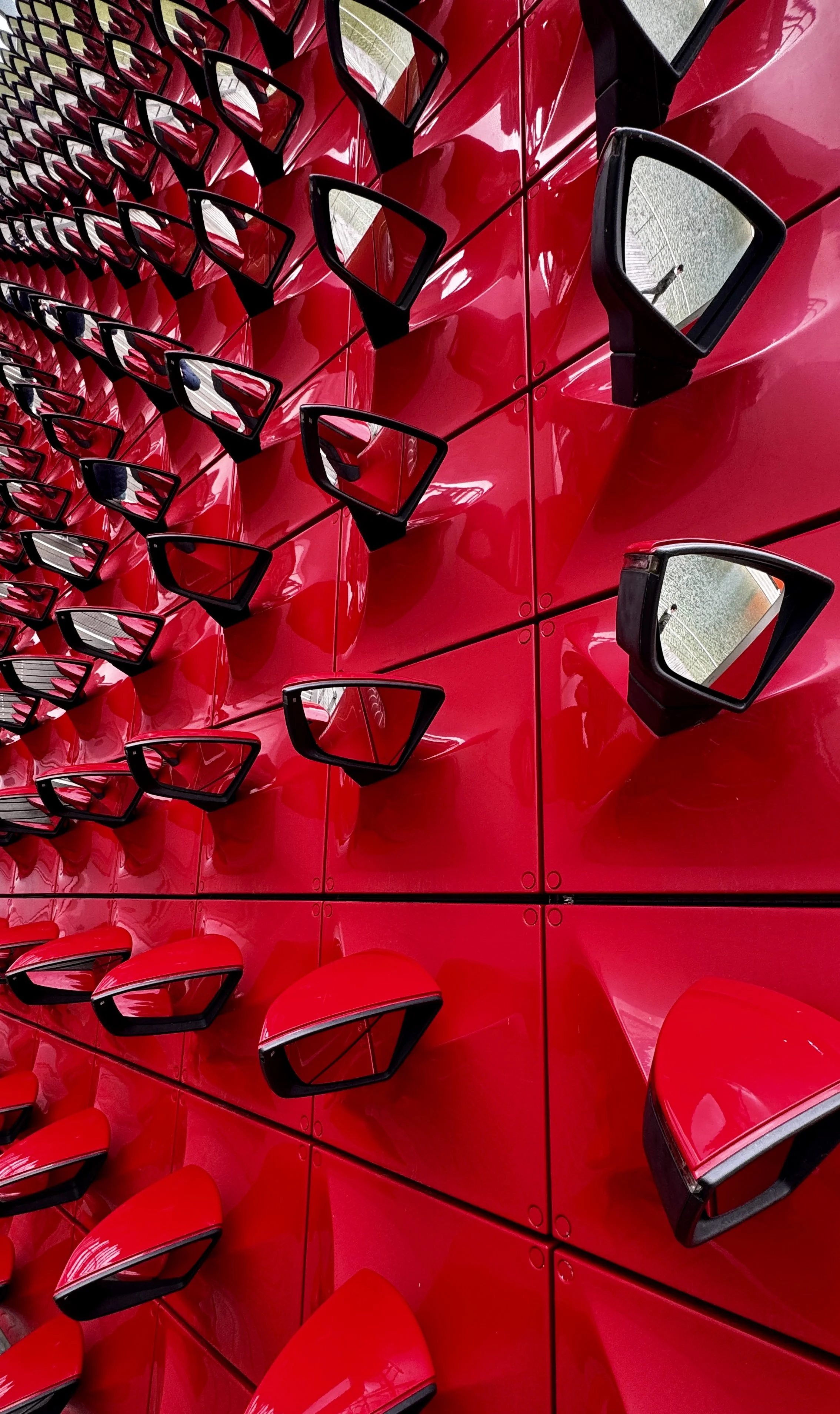 automotive art installation featuring red side mirrors at Autostadt in Wolfsburg, Germany.