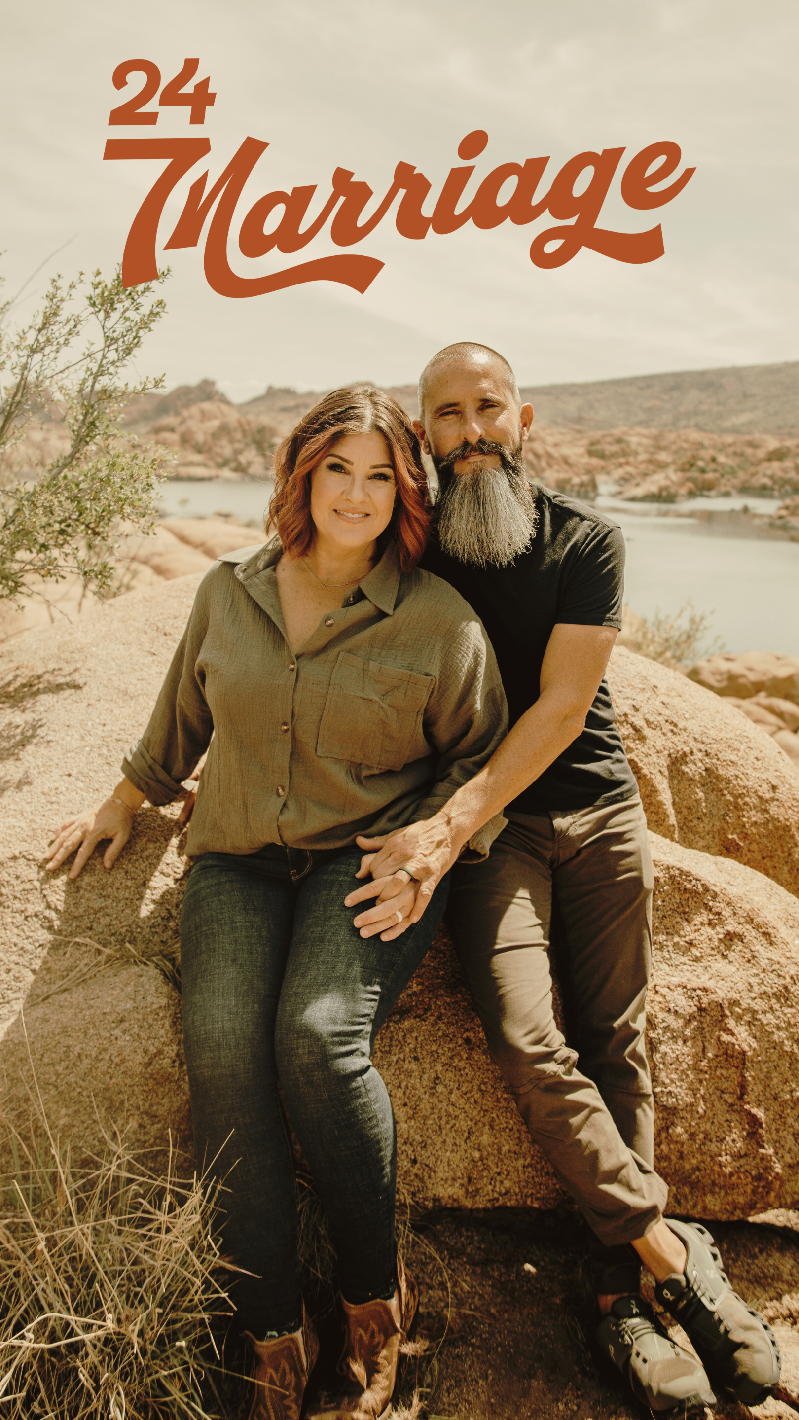 A couple sitting on a large rock in a desert landscape near a body of water, with the text '24 Marriage' in the top left corner.