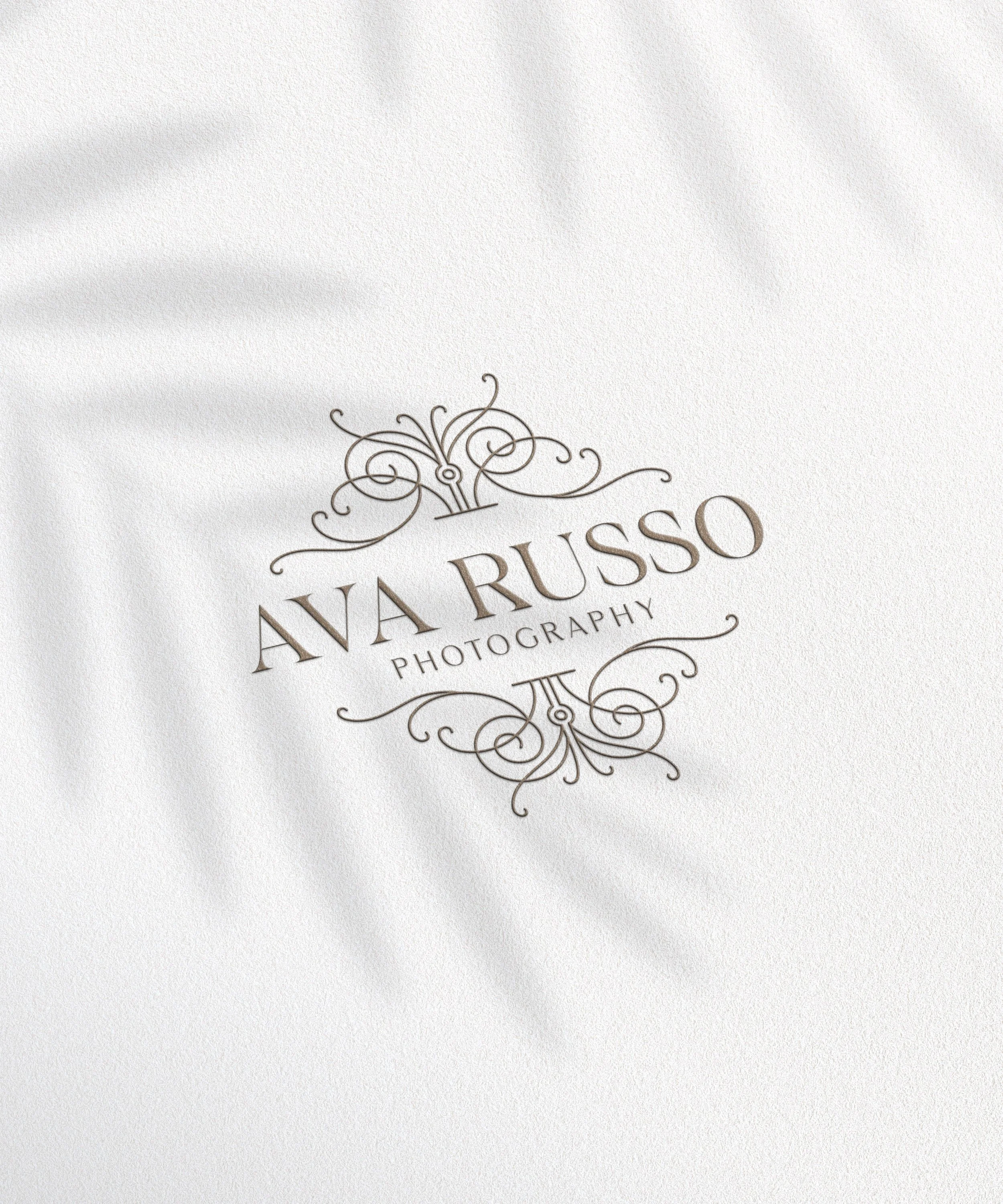 Elegant logo design for Ava Russo Photography on white textured paper with decorative flourishes.
