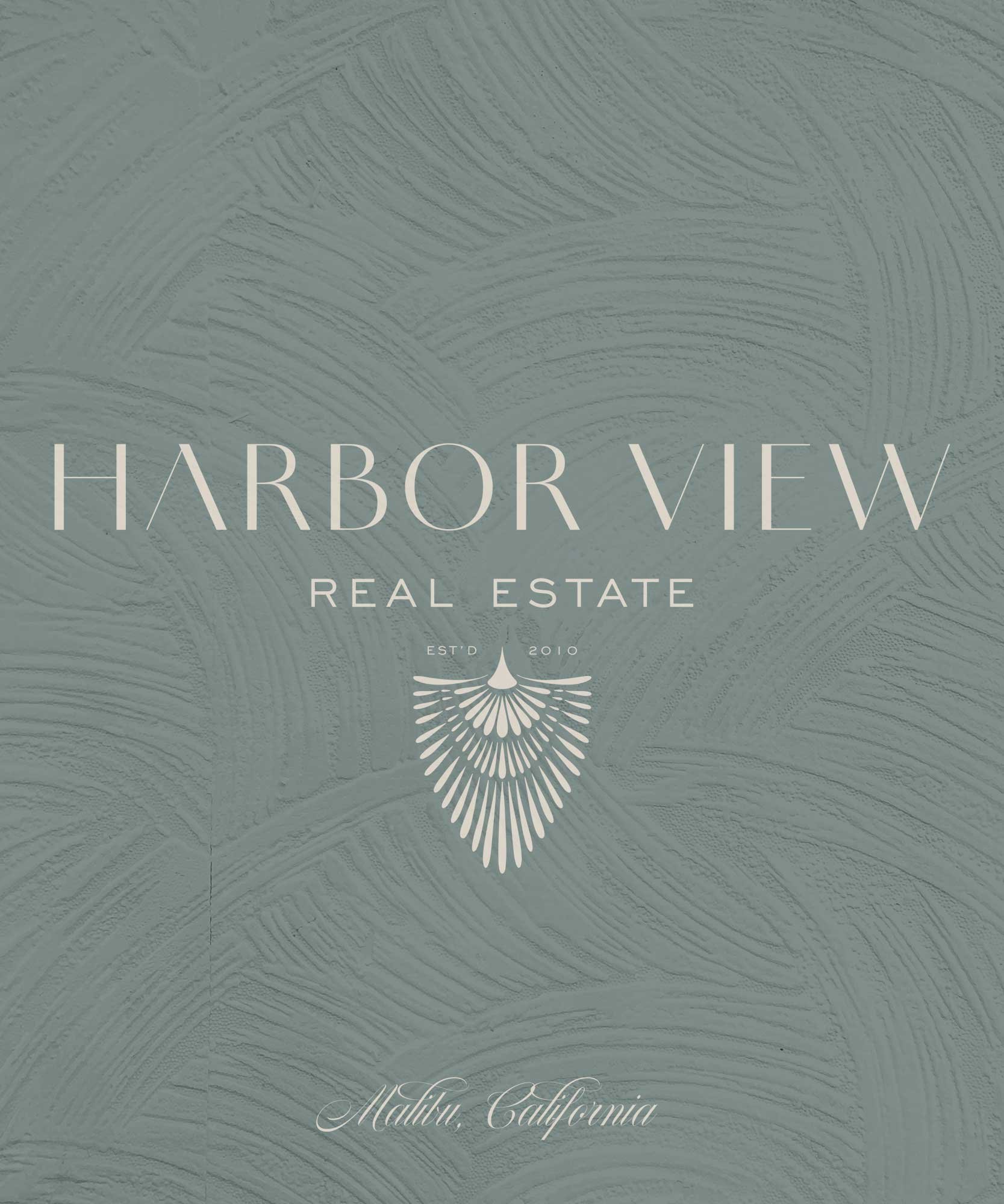 Design for Harbor View Real Estate featuring a textured bluish-green background with white text and a decorative emblem, indicating the company's establishment in 2010 in Malibu, California.