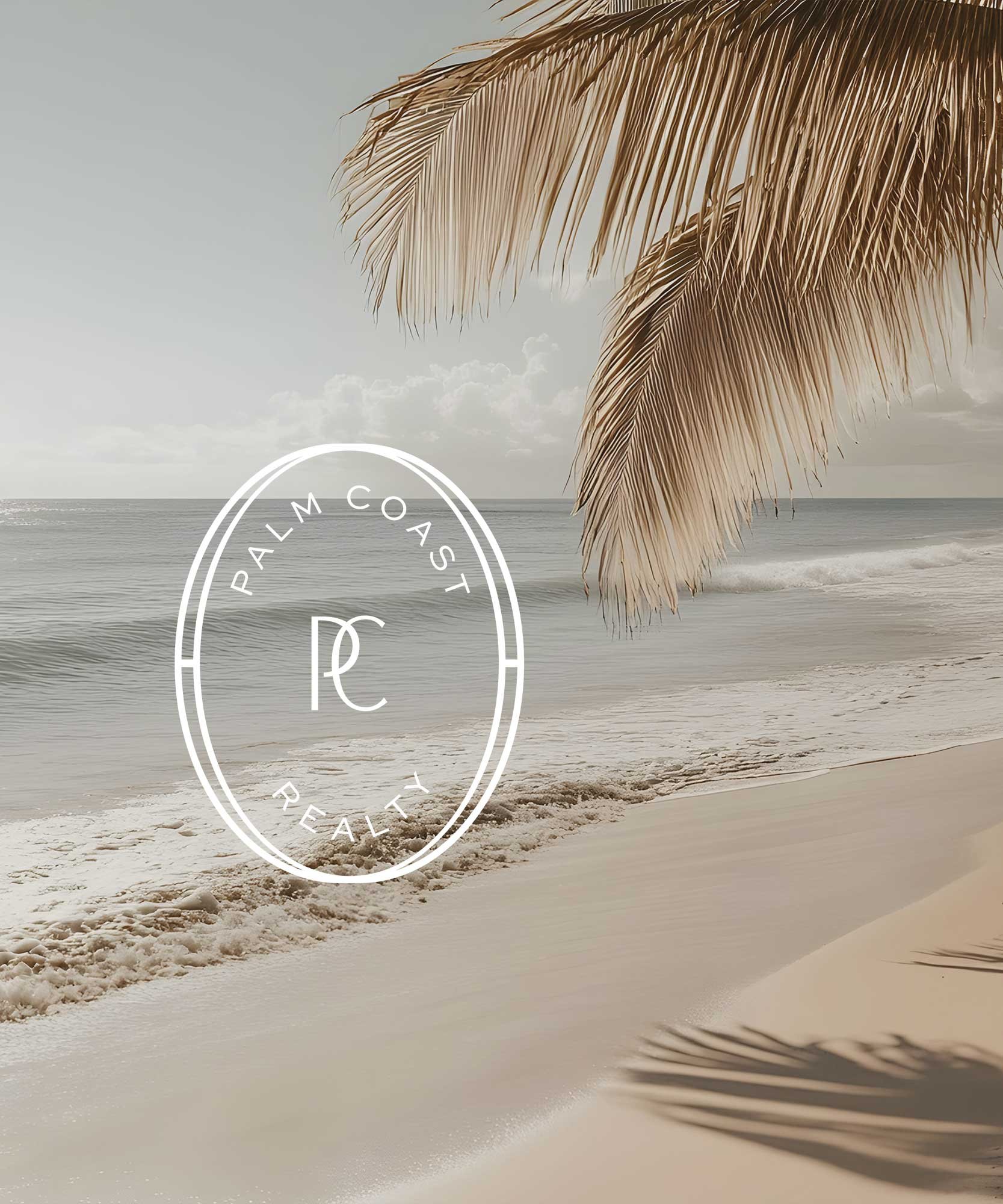 Beige sandy beach with calm ocean waves, a dry palm frond hanging overhead, and a semi-transparent white logo with the text "Palm Coast Realty" in the middle.