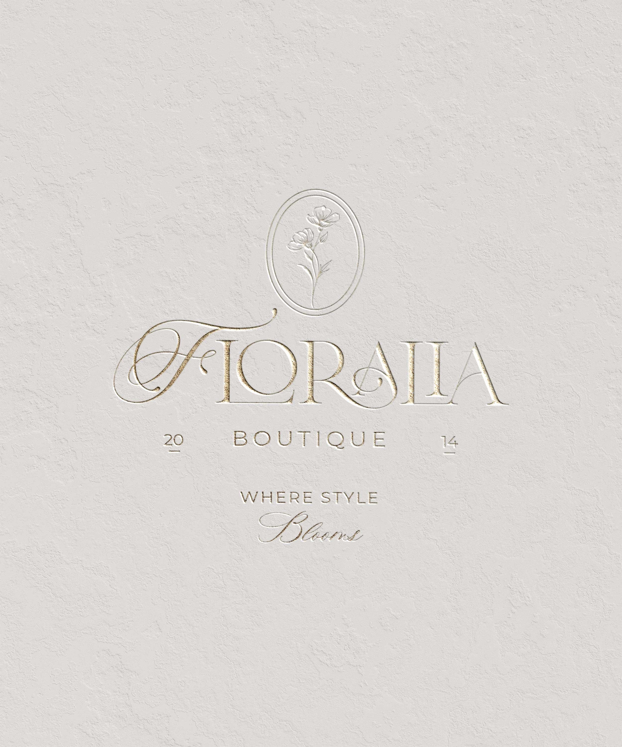 Elegant cream-colored textured background with gold embossed floral logo, reading "Floralia Boutique 2014," with the tagline "Where Style Blooms" in script font.