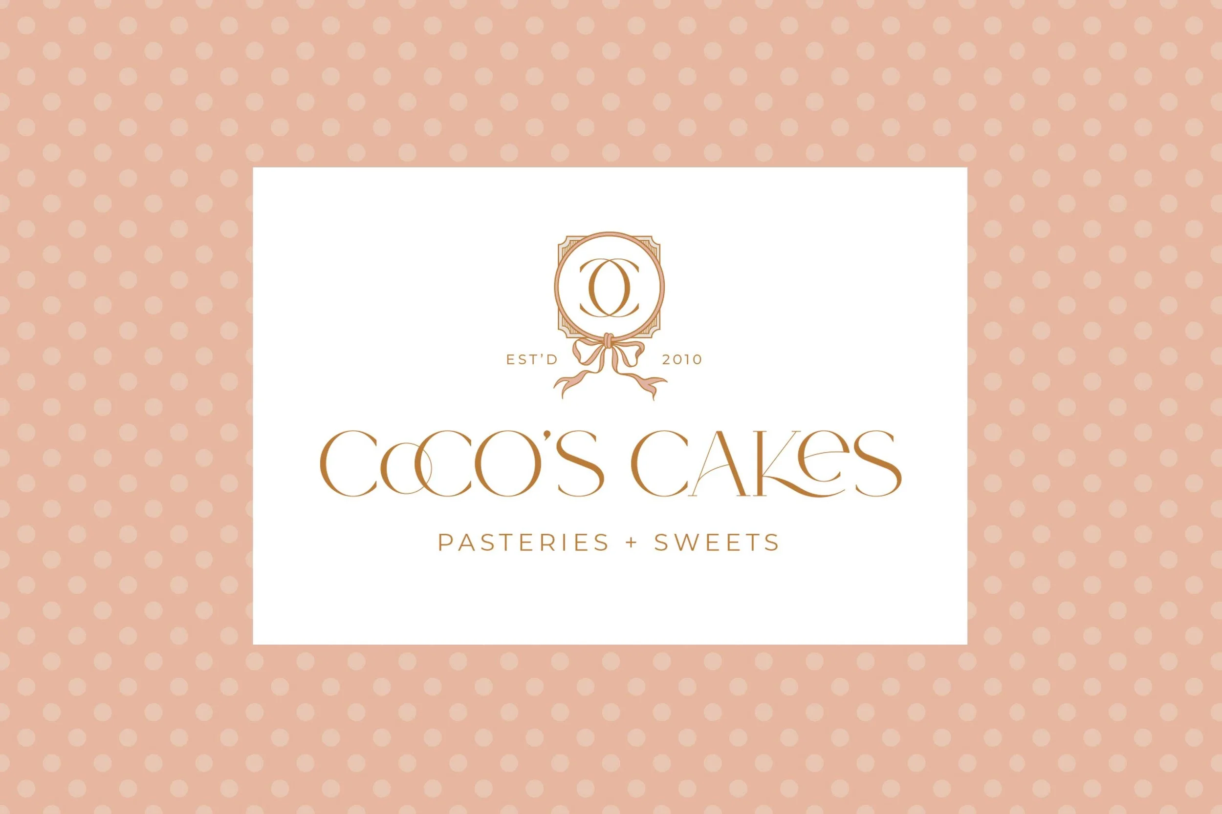 Logo for Coco's Cakes, a bakery specializing in pastries and sweets, with a decorative emblem featuring a stylized letter 'O' and a bow, on a pink polka dot background.