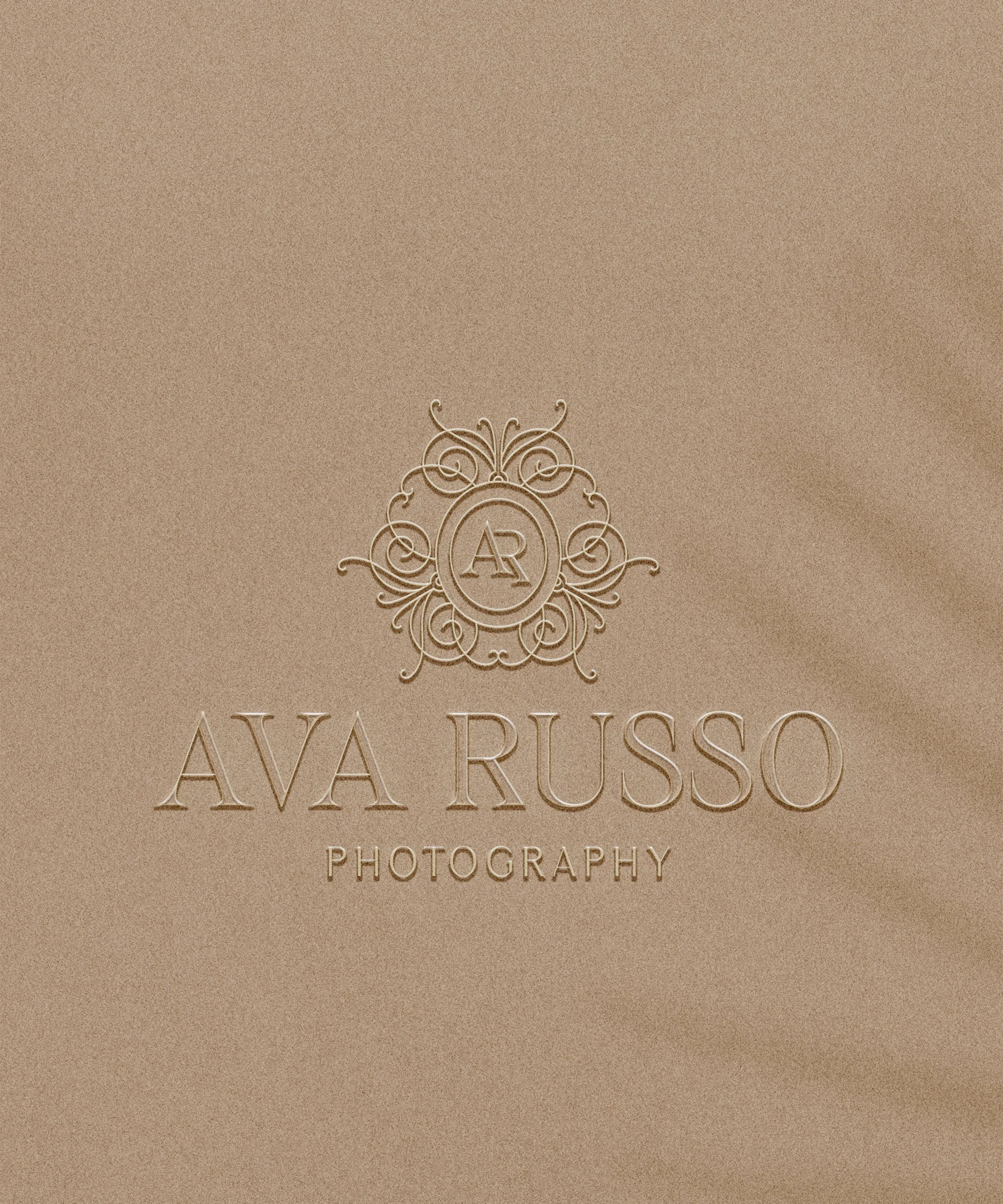 Elegant beige background with a logo and text for Ava Russo Photography, featuring a decorative emblem with initials 'AR' at the top.