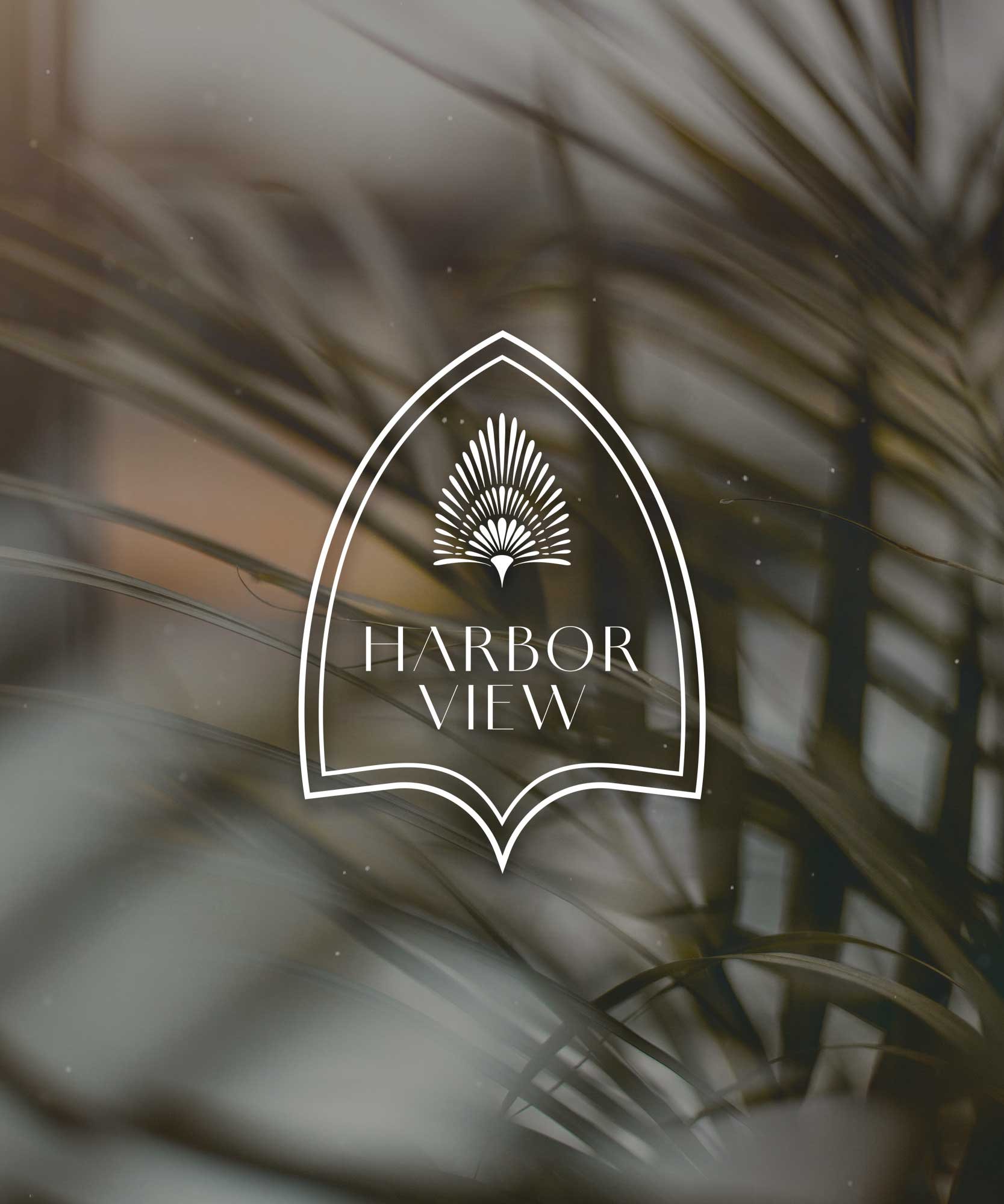 Logo for Harbor View, featuring a stylized palm leaf inside an arched frame, over a background of blurred palm leaves.