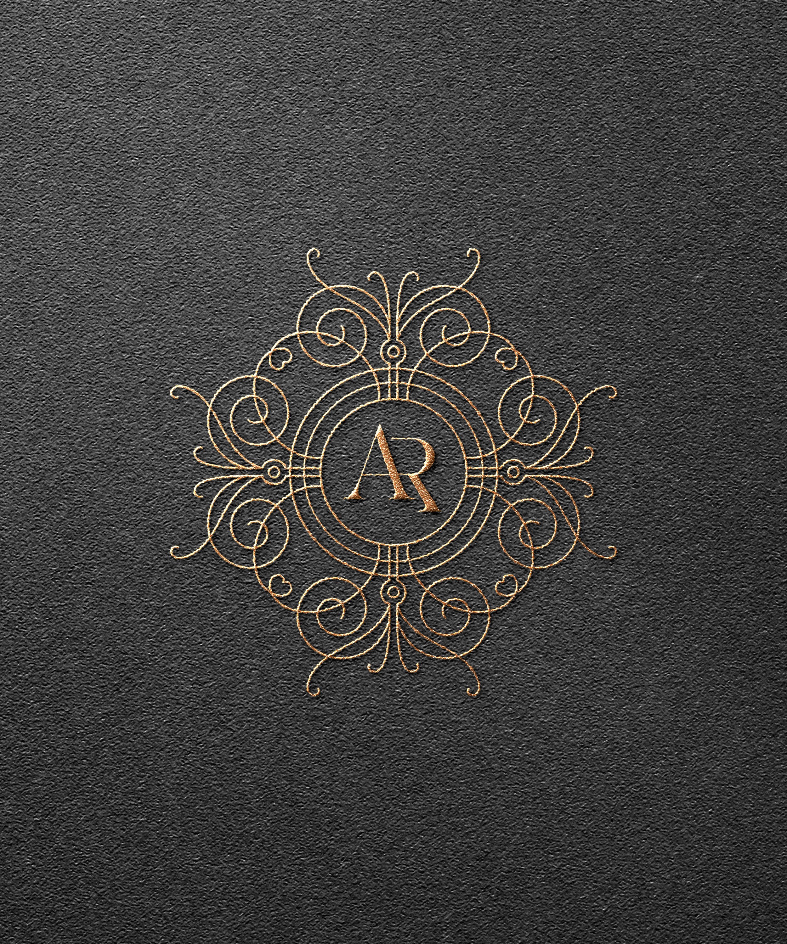 Elegant gold monogram logo with the letters A and R on a textured black background.
