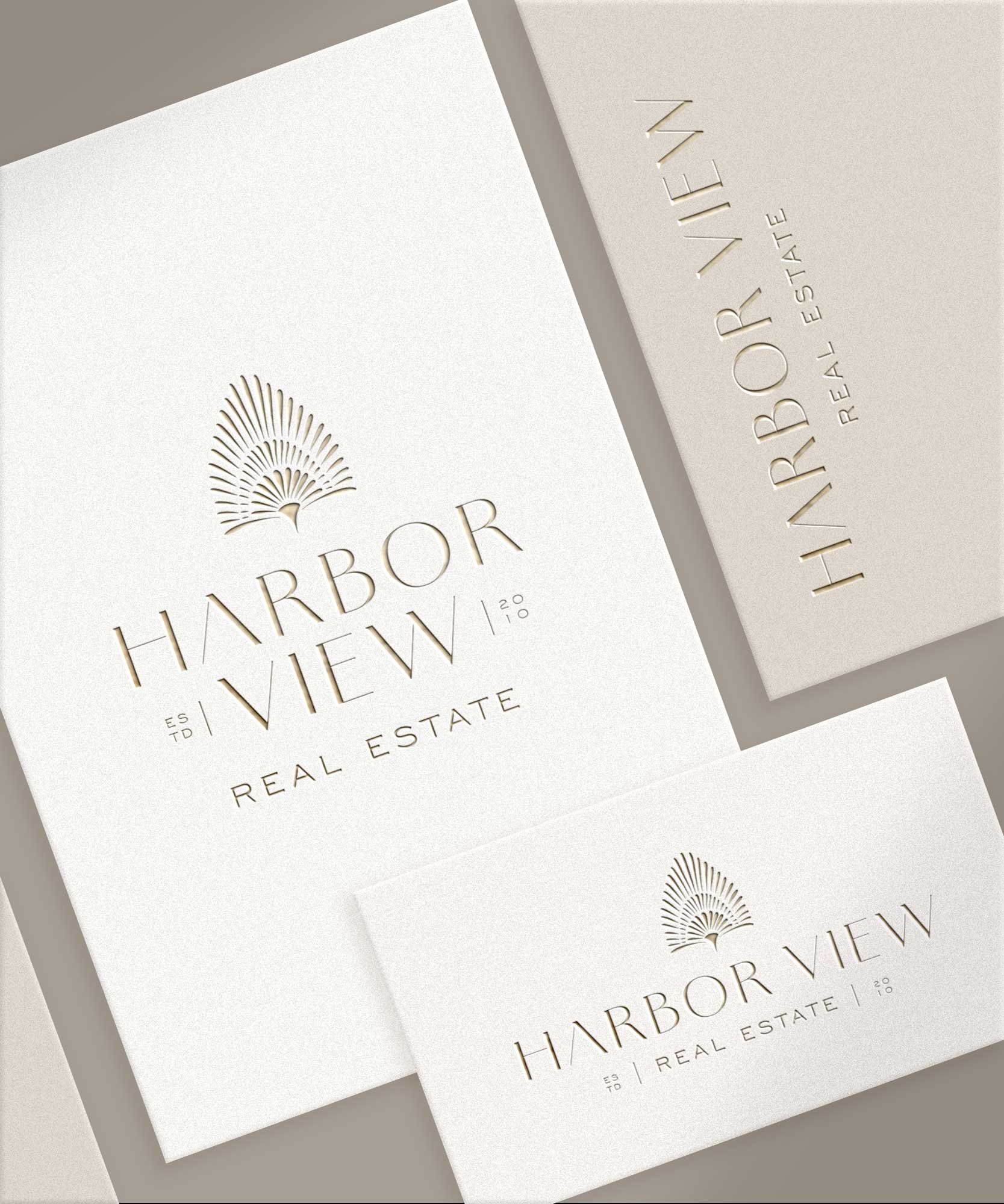 Logo for Harbor View Real Estate, featuring a stylized palm tree and subtle text, on several printed materials.