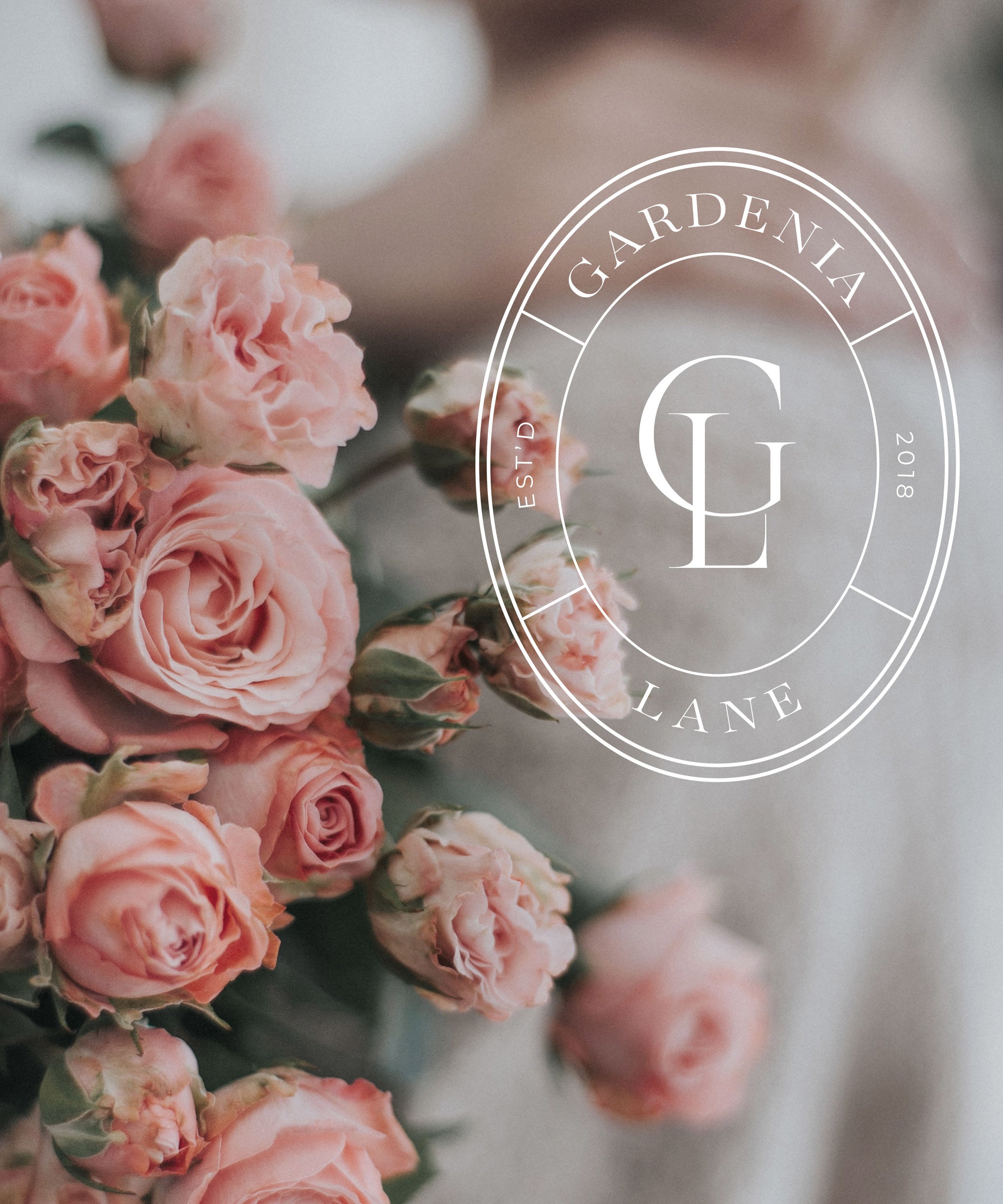 A bouquet of pink and peach roses with a semi-transparent overlay containing a circular logo with the text 'Gardenia Lane', ESTD. 2018, and initials LG in the center.