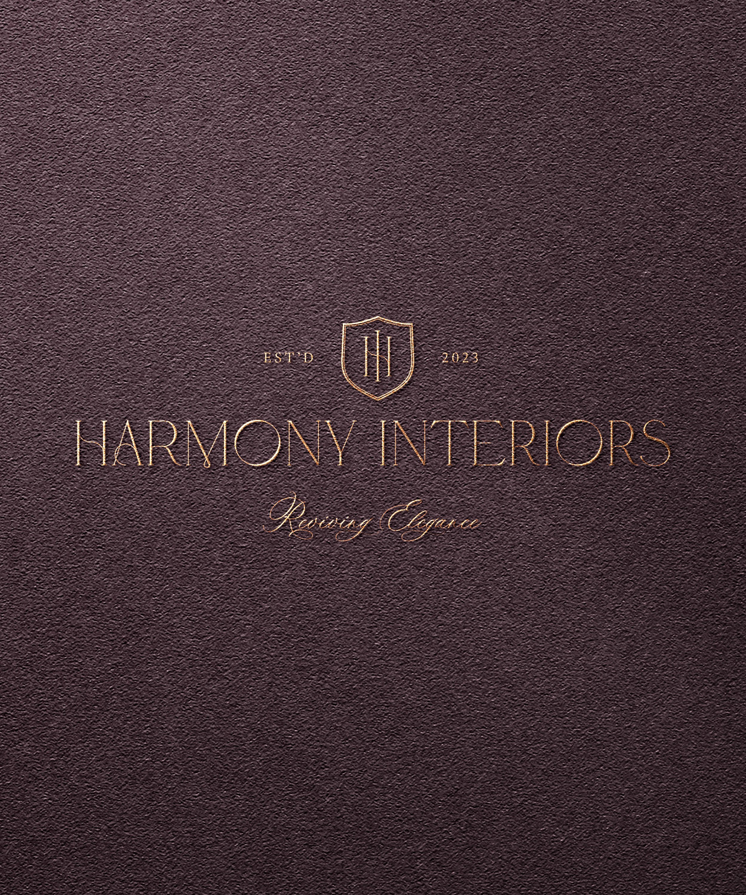 Dark brown textured interior design portfolio cover with gold embossed text, logo, and the words 'Harmony Interiors, Refining Elegance, Estd 2023' in elegant font.